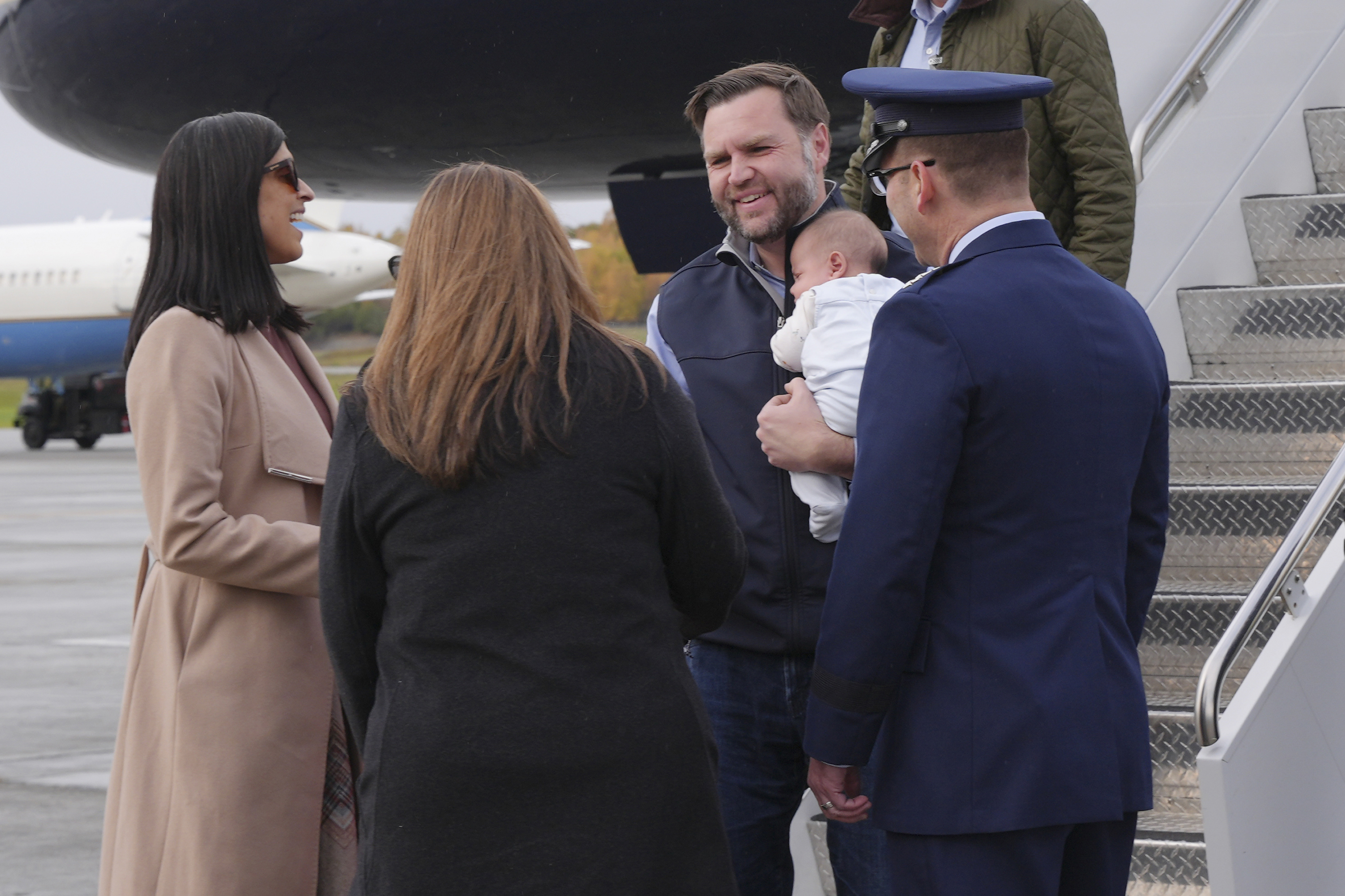 JD keeps Alec in his arms after stepping off Air Force Two as Usha stands nearby at Elmendorf Air Force Base. | Source: Getty Images