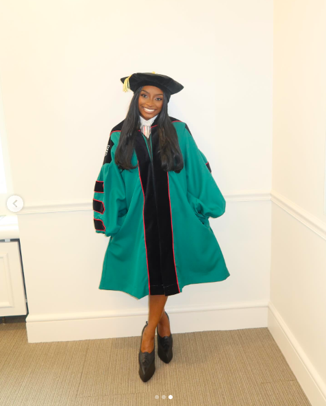 Simone Biles posing for a picture in graduation attire, posted on May 12, 2025. | Source: Instagram/simonebiles
