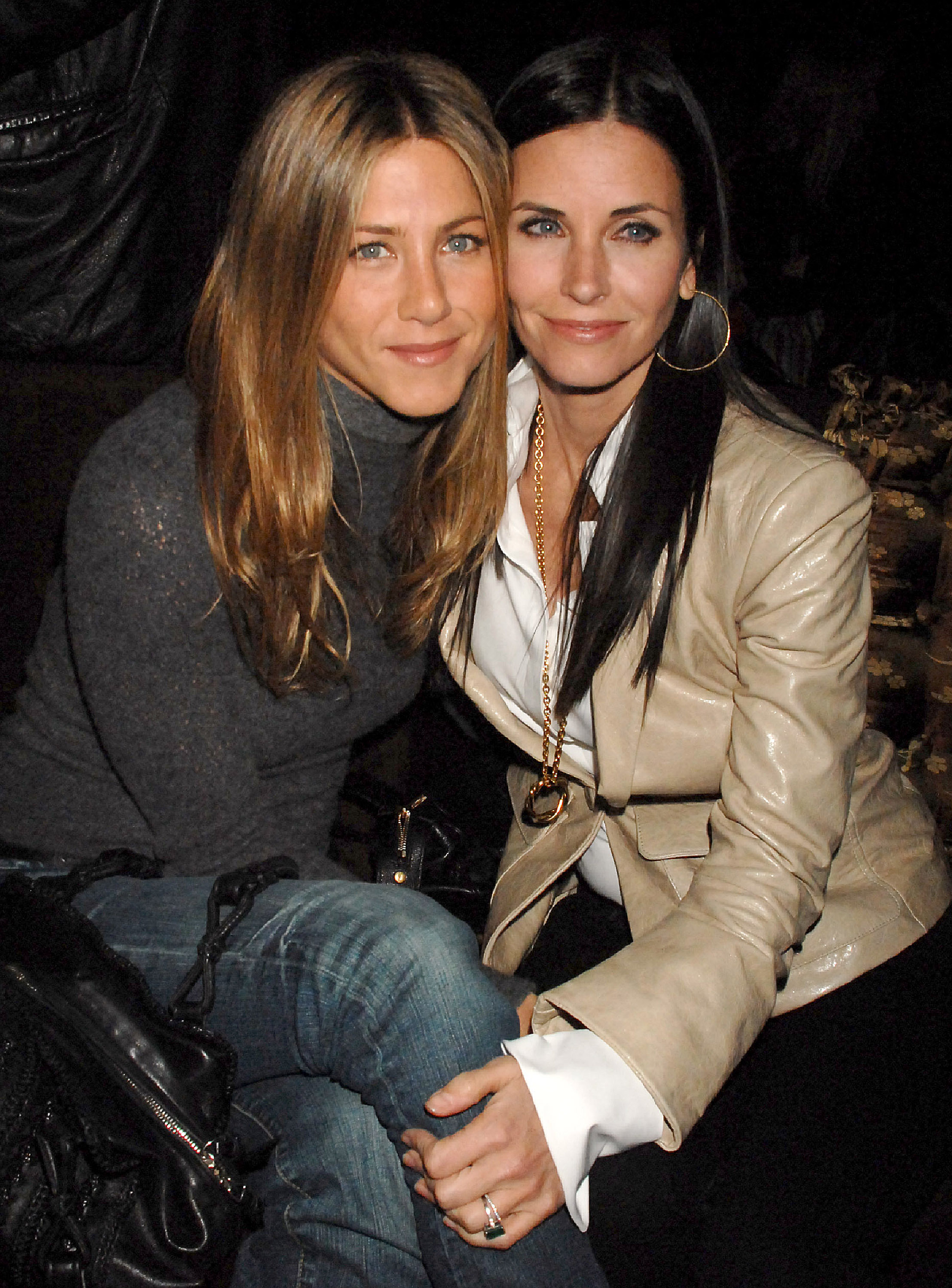 Jennifer Aniston and Courteney Cox during "The Tripper" Los Angeles premiere at Hollywood Forever Cemetery in Hollywood, California. They pose sweetly with their cheeks touching, their radiant glow lighting up the photo.