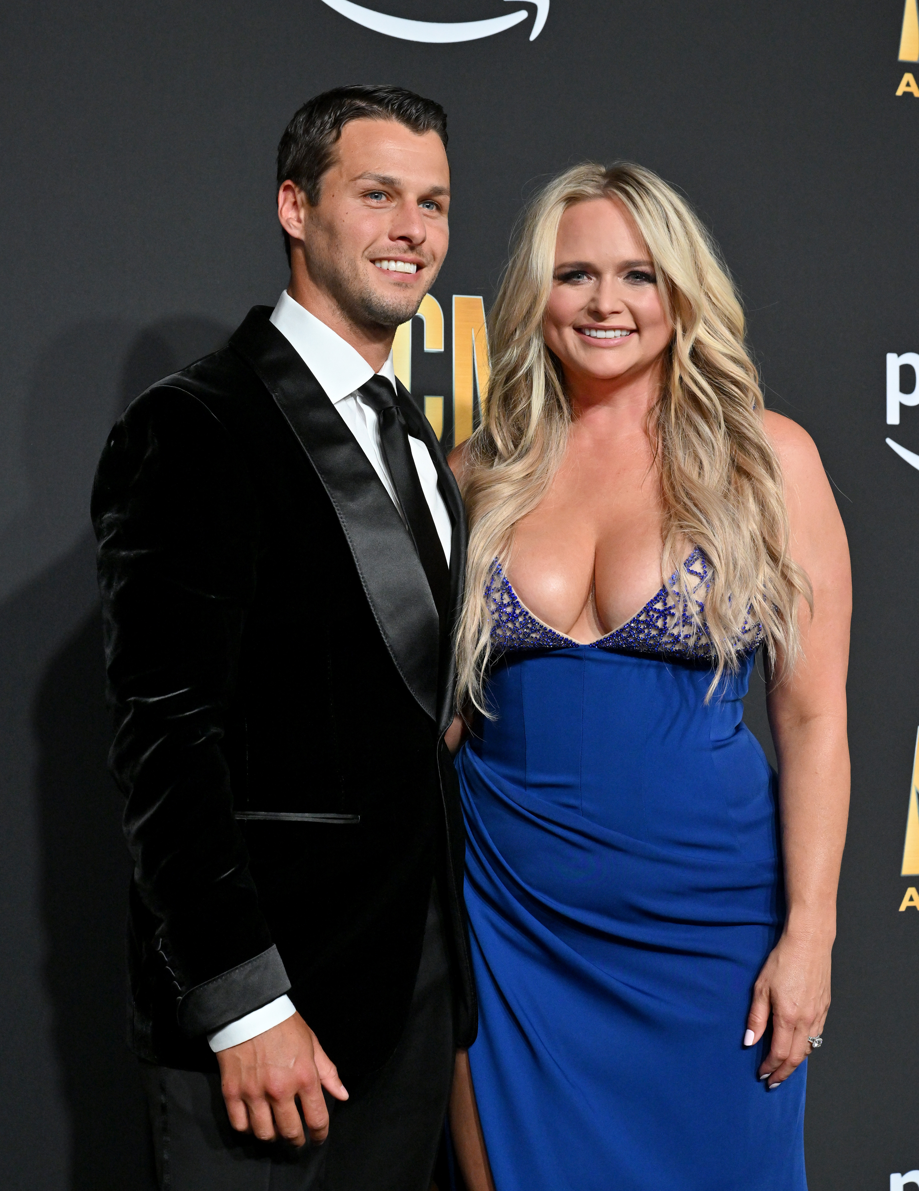 Glamour was in high gear as Brendan McLoughlin and Miranda Lambert graced the red carpet at the 58th Academy of Country Music Awards on May 11, 2023, in Frisco, Texas. Miranda dazzled in a cobalt-blue gown featuring an intricately beaded plunging neckline, while McLoughlin stood sharply by her side in a black velvet tuxedo jacket, satin lapels, and a crisp white shirt paired with a dark tie. | Source: Getty Images