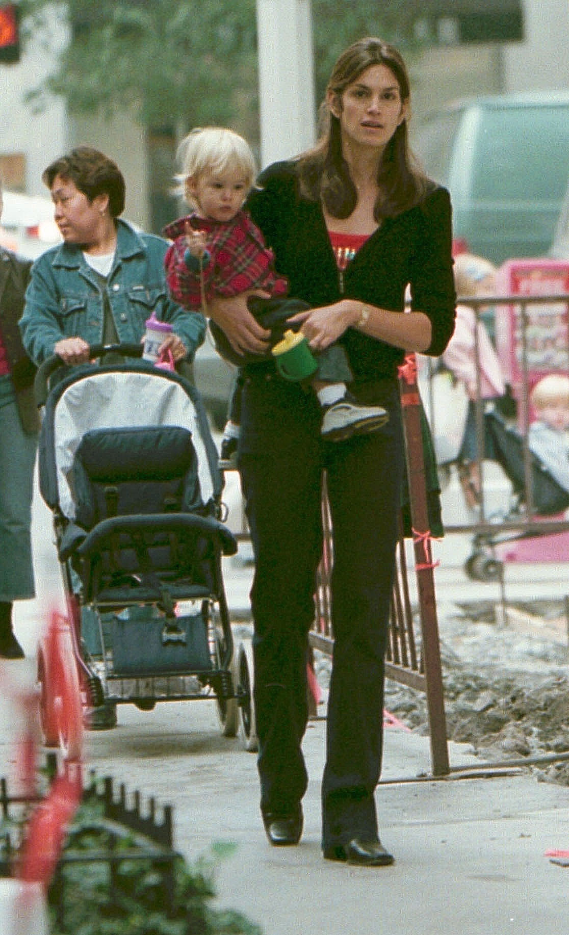 Cindy Crawford carries her young son Presley Gerber while out together in 2000, offering a glimpse of the model as a child long before he would follow his mother into the spotlight. | Source: Getty Images