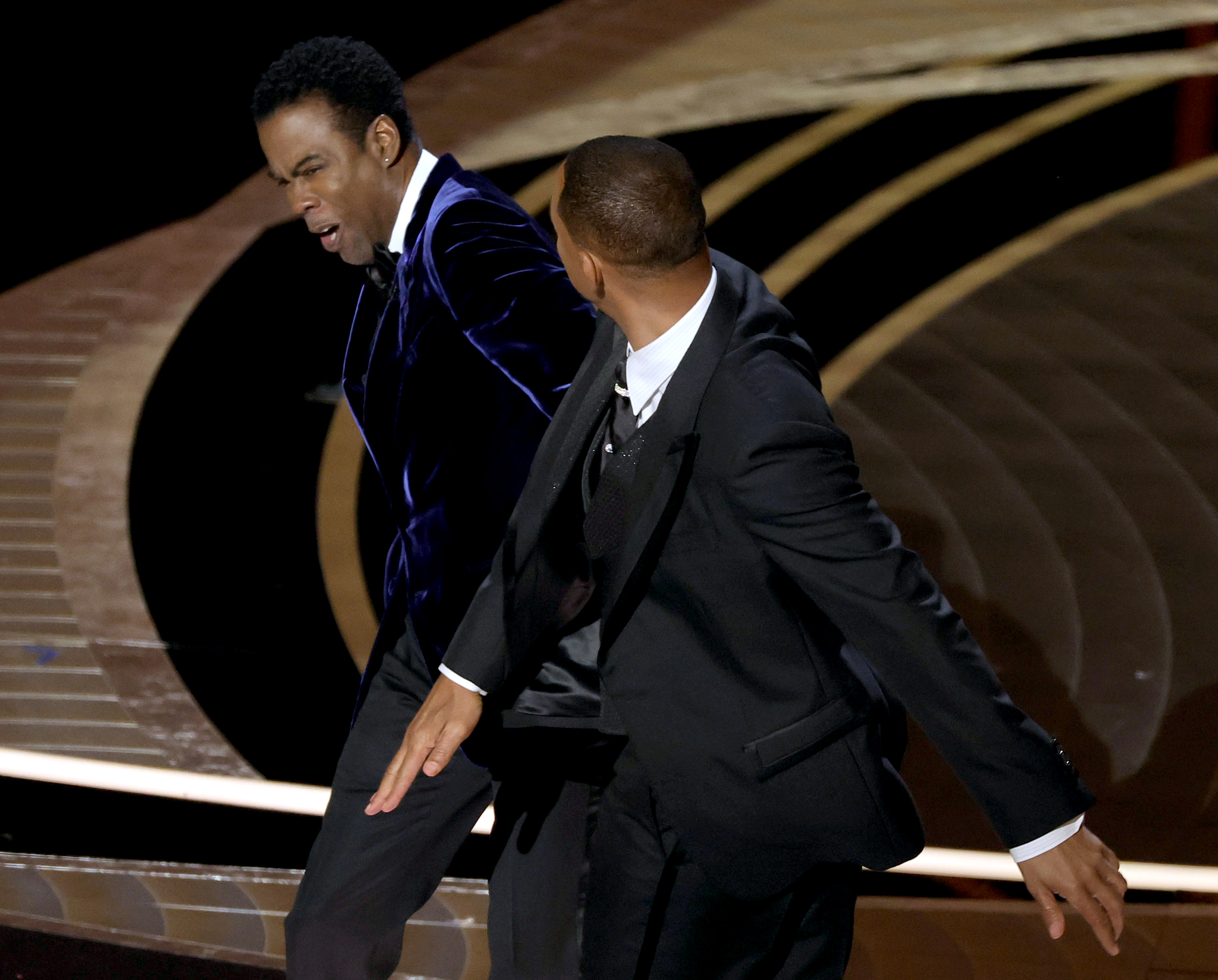 Will Smith appears to slap Chris Rock onstage during the 94th Academy Awards in Hollywood, California on March 27, 2022 | Source: Getty Images
