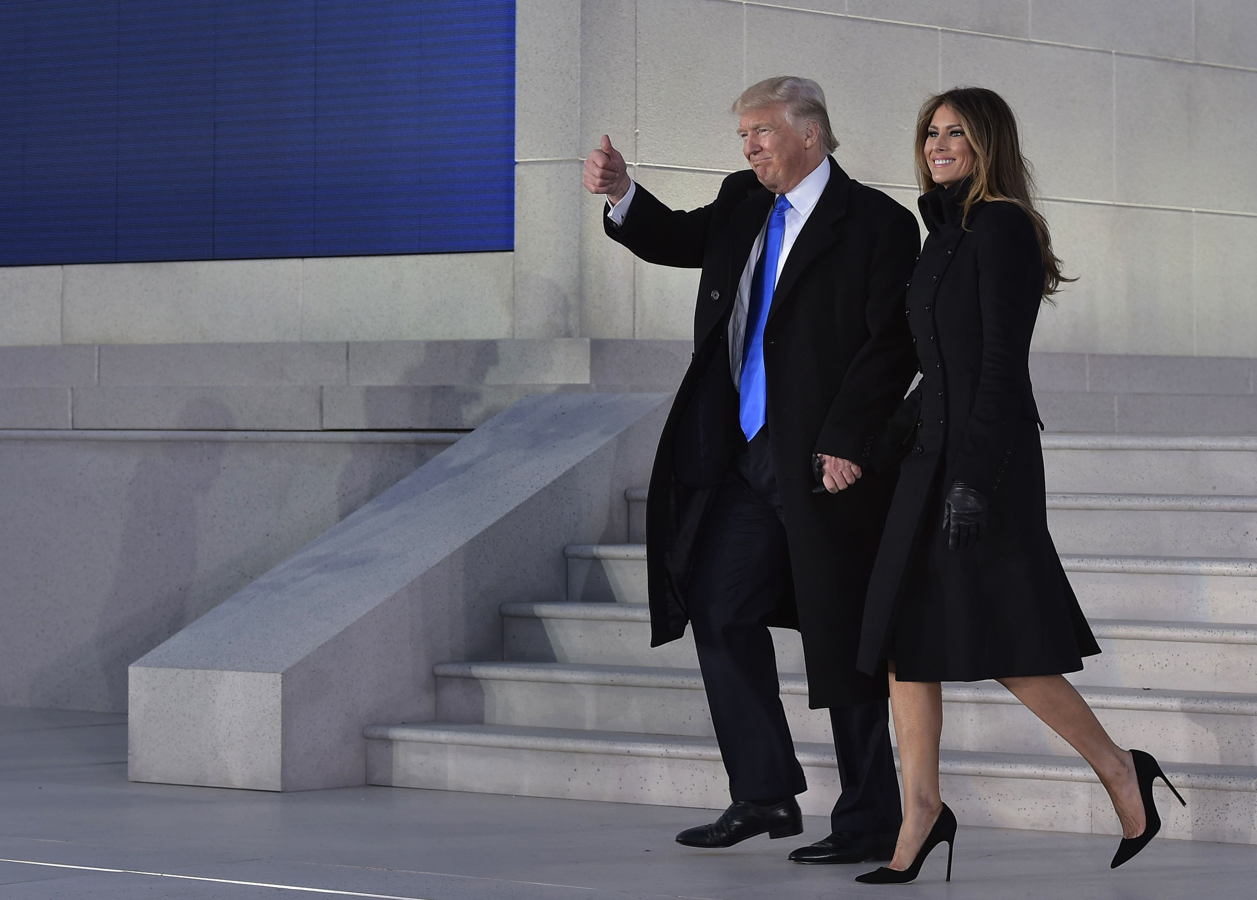 Melania Trump arrives for a pre-inauguration welcome celebration at the Lincoln Memorial in Washington, D.C., on January 19, 2017, wearing a military-inspired, double-breasted black coat dress with black gloves, styled with sharp black pointed-toe stiletto pumps that provide a classic, sky-high lift down the stone steps.