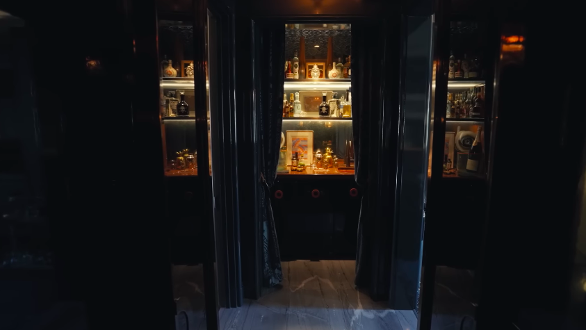 The backlit bar nook is one of the tour's most cinematic reveals. It feels like a hidden speakeasy tucked inside a family townhouse. | Source: YouTube/Architectural Digest