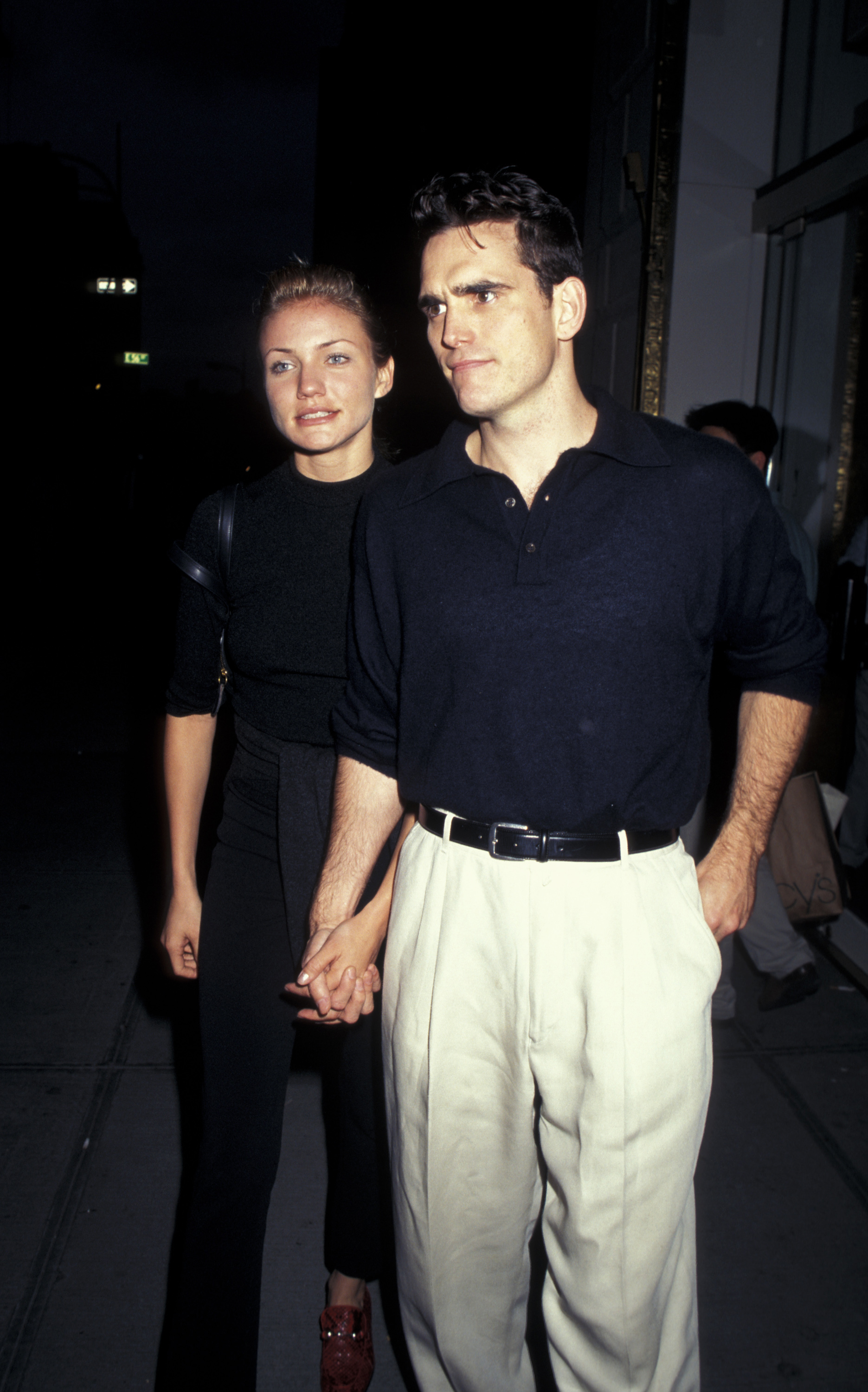 Cameron Diaz walks hand-in-hand with Matt Dillon as they attend a Central Park benefit at the Plaza Hotel in New York City, both dressed in understated, coordinated dark outfits for the evening event.