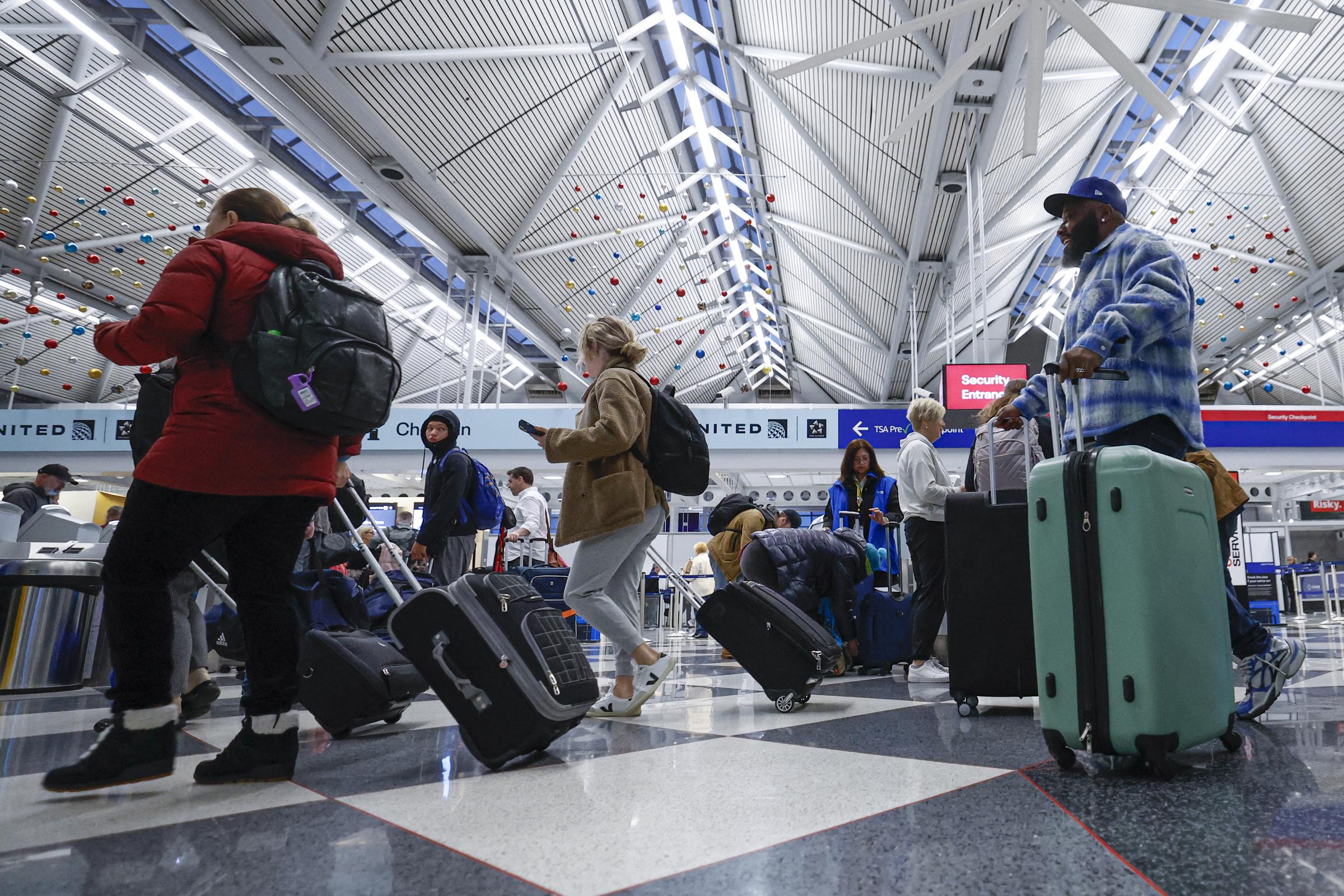 Travelers walk through O'Hare International Airport in Chicago, Illinois, on November 22, 2024 | Source: Getty Images