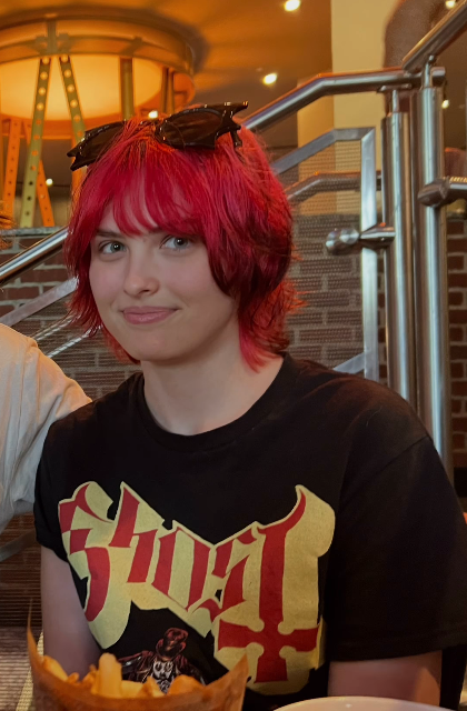 Sporting a vibrant crimson-red shag haircut and a casual graphic tee, 20-year-old Dannielynn Birkhead embraced an edgy, alternative aesthetic in a candid snapshot shared from a happy birthday tribute video collage posted on September 7, 2026. With dark sunglasses perched playfully atop her blunt bangs and an effortless, confident smile, the image highlights a striking evolution away from her formal red-carpet attire into a relaxed, contemporary personal style. | Source: Instagram/larryanddannielynn