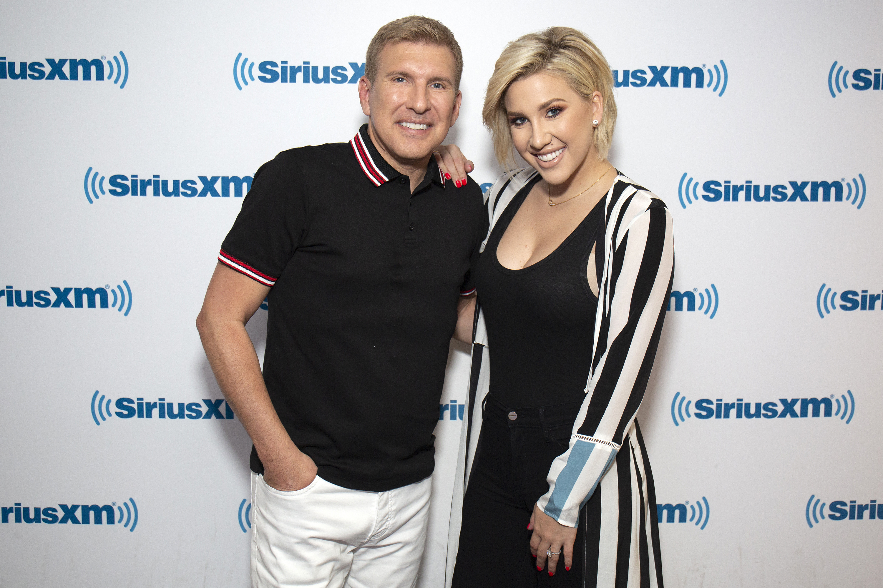 Savannah Chrisley poses with her father, Todd Chrisley, during a visit to SiriusXM Studios in New York City on June 12, 2019. Her recent pregnancy announcement prompted congratulatory messages and playful comments about Todd becoming a grandfather. | Source: Getty Images