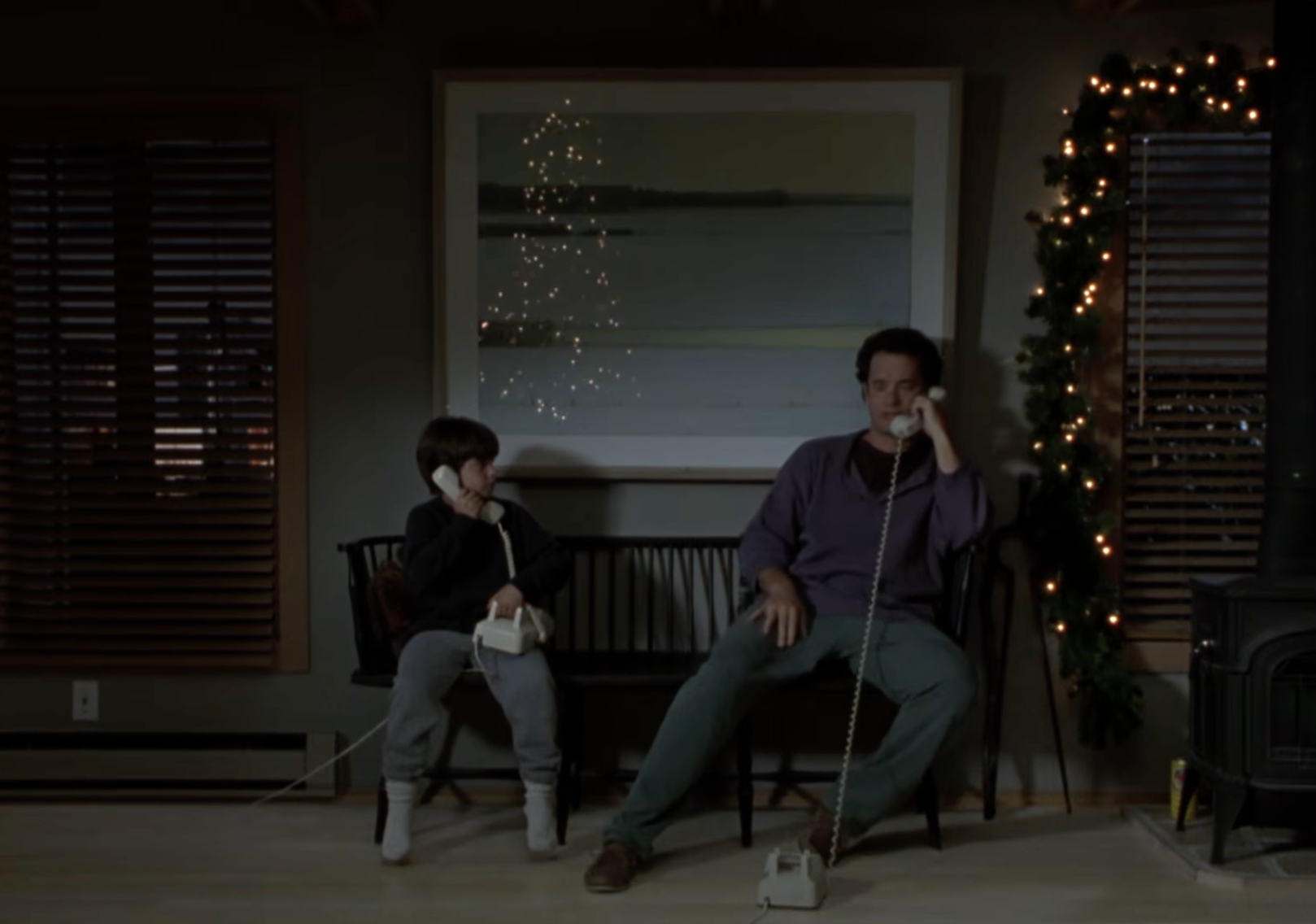 A young boy and his on-screen father speak on separate phones in a memorable scene from Sleepless in Seattle. The Christmas Eve phone call becomes a turning point in the beloved romantic comedy.