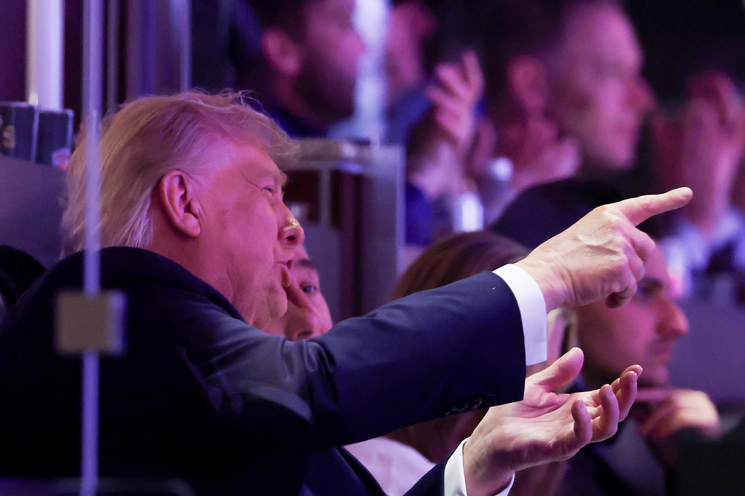 Donald Trump gestures while speaking with Knicks owner James Dolan during Game 3 of the NBA Finals. A forensic lip reader later analyzed the exchange, revealing a conversation that appeared to center on an unnamed individual and a possible attempt to mend a strained relationship. | Source: Getty Images