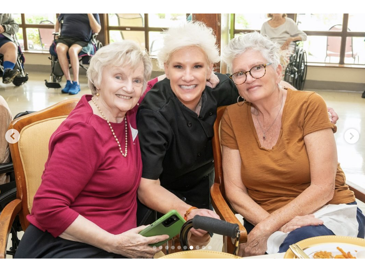 Anne Burrell is seen with two elderly residents in a picture dated June 11, 2025 | Source: Instagram/careritecenters