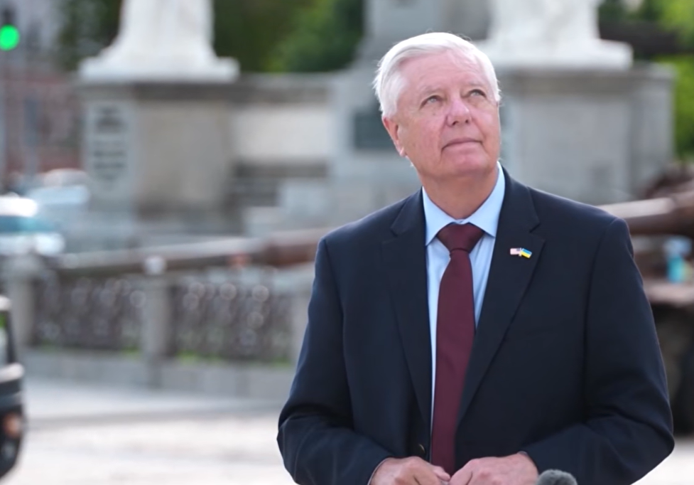Lindsey Graham pauses and looks skyward during an outdoor news conference in Ukraine, moments after church bells rang in the background, before continuing his remarks on support for Ukraine and proposed sanctions against Russia. | YouTube/APT