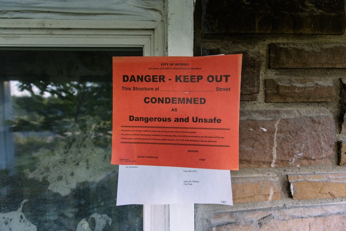A red condemnation notice warned that the house had been declared dangerous and unsafe. After the demolition, materials salvaged from the property were later incorporated into the special reissue of "The Marshall Mathers LP." | Source: Facebook/eminem