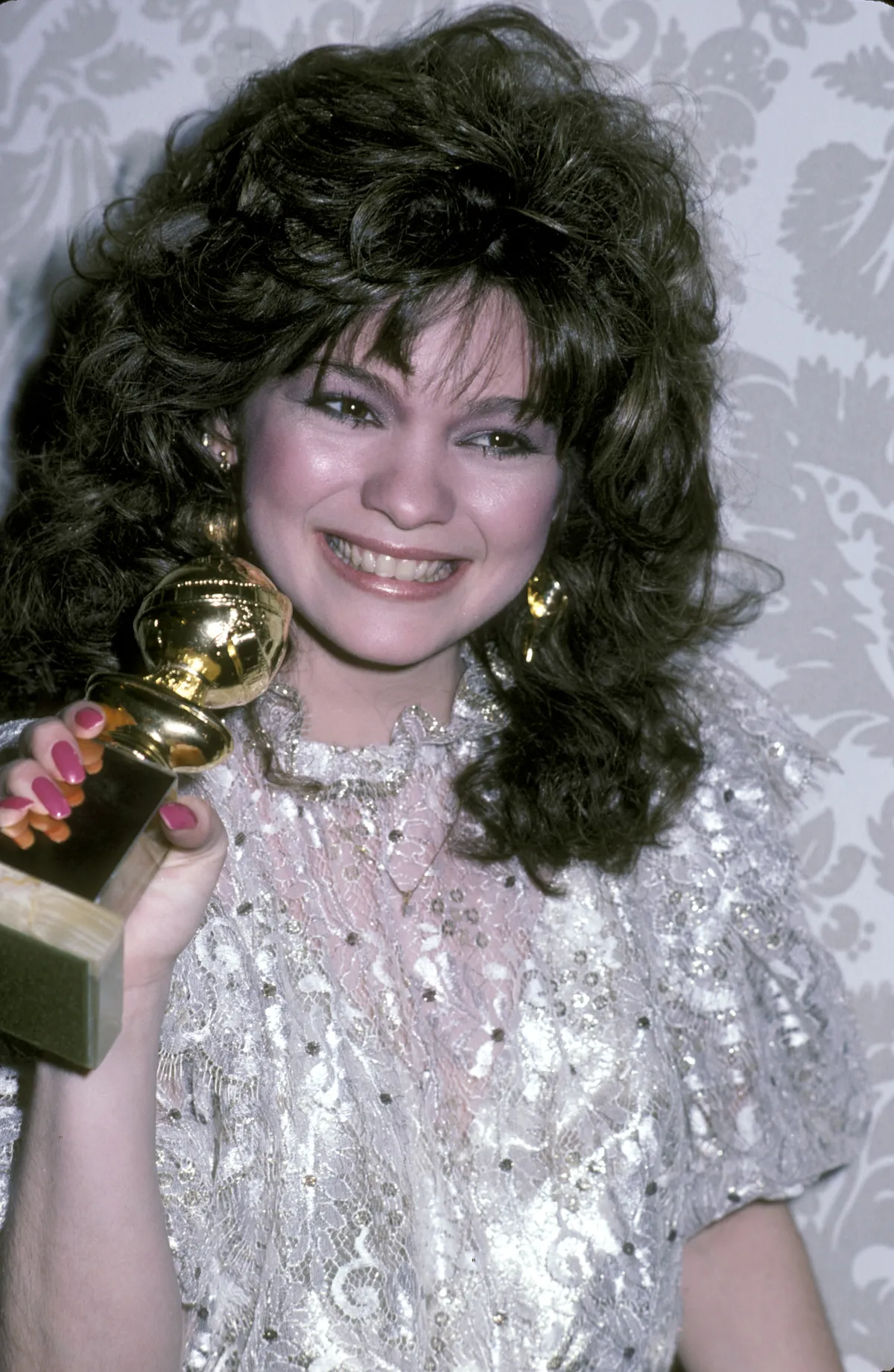 Valerie Bertinelli attends an event at the Beverly Hilton Hotel in Beverly Hills, California, looking stunning with a voluminous black hairstyle. Her puffed-up curls frame her face beautifully, with soft bangs that accentuate her cheeks and cascade gracefully to her shoulders.