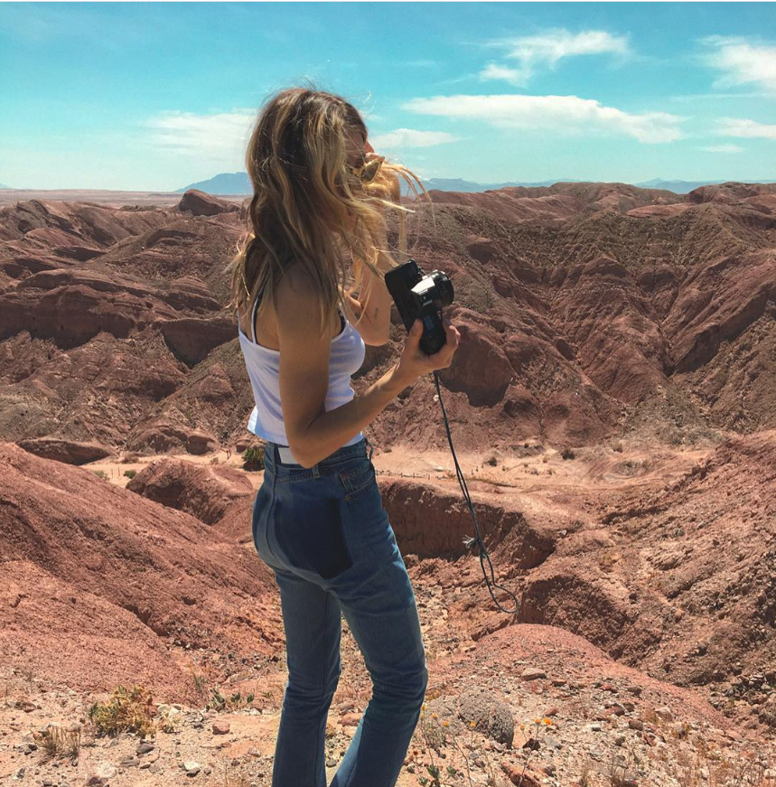 A photo of Janell Shirtcliff holding a camera.  | Source: Instagram/janellshirtcliff