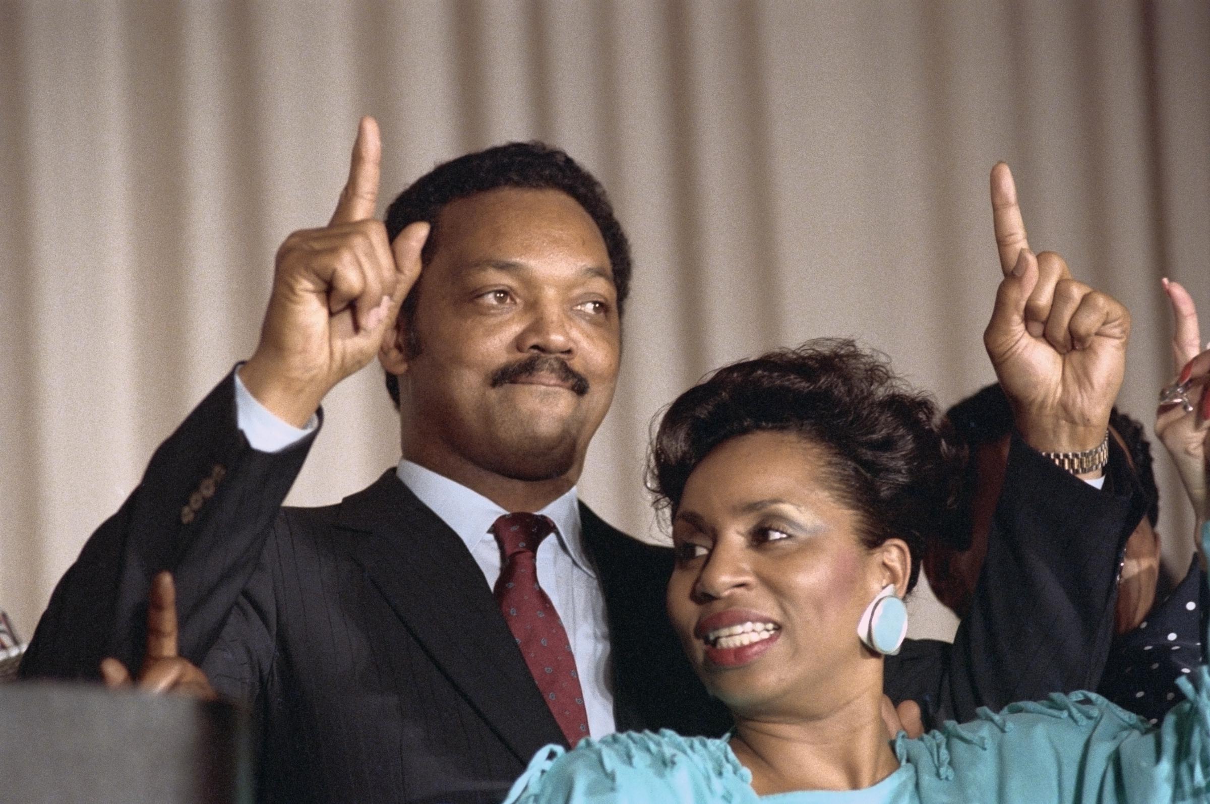 Jesse Jackson and his wife Jackie Jackson celebrate his victory in the District of Columbia primary as they sing "We Are One" at a victory rally on May 3, 1988, in Washington, DC | Source: Getty Images
