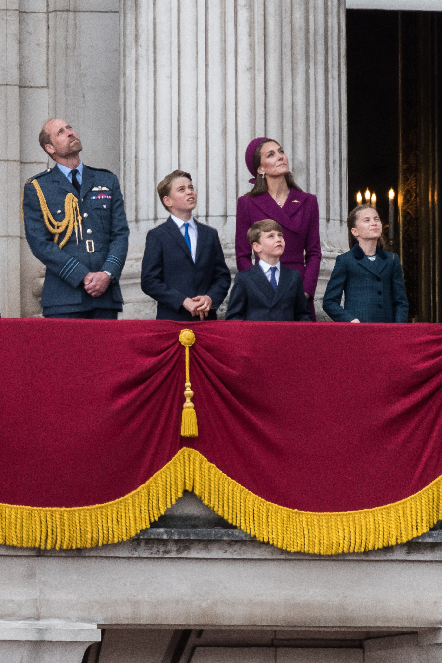 Prince William, Prince George, Prince Louis, Princess Catherine, and Princess Charlotte watching the flypast during VE Day. | Source: Getty Images
