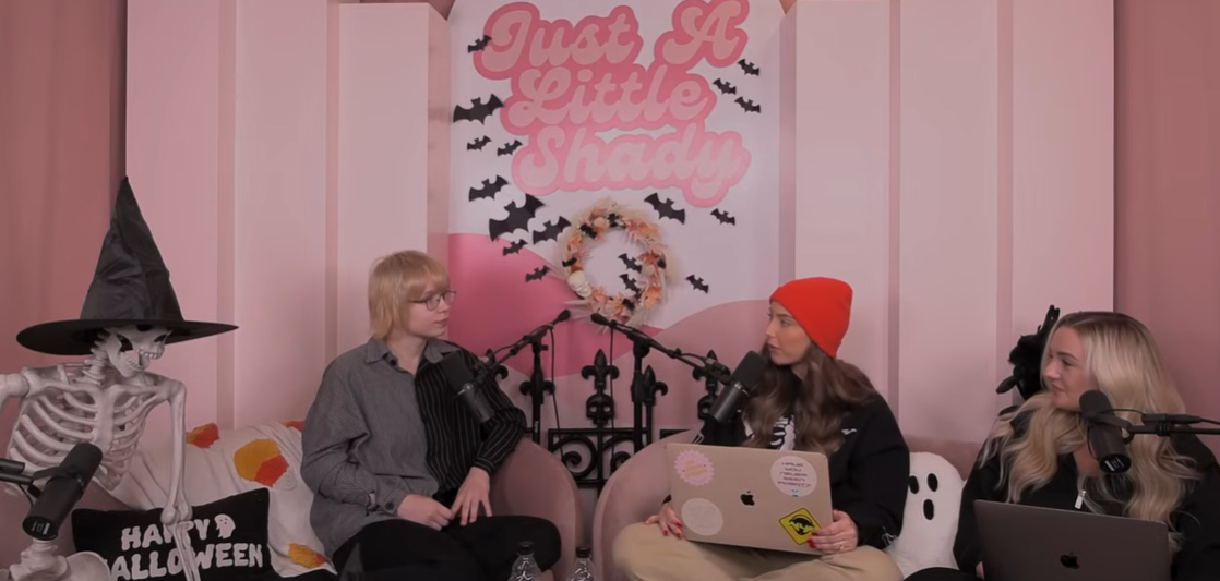 Stevie Laine Scott listens while seated on the podcast set, appearing in conversation with Hailie Jade and co-host Brittany Broski, posted in November 2023 | Source: YouTube/justalittleshadypodcast