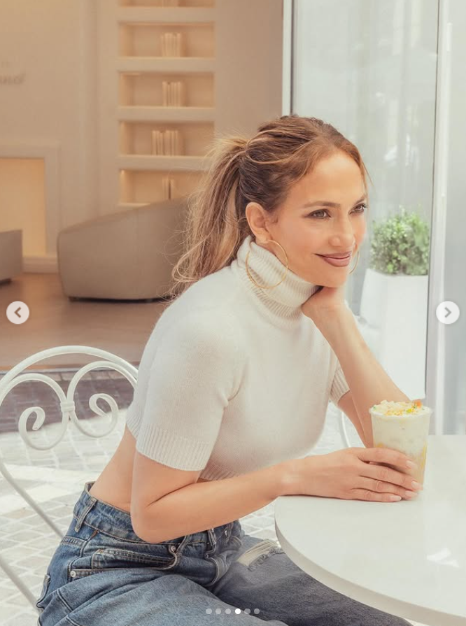 Jennifer Lopez holding a JLo Birthday Cake latte at a La La Land Cafe in Los Angeles, California, from a post dated July 23, 2025. | Source: Instagram/jlo