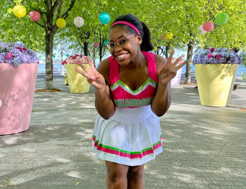Carla Jeffery smiles for the camera in her signature Seabrook cheerleading uniform, capturing the bright, playful spirit she brought to her role as Bree in Disney Channel’s Zombies. | Source: Instagram/chandlerlkinney