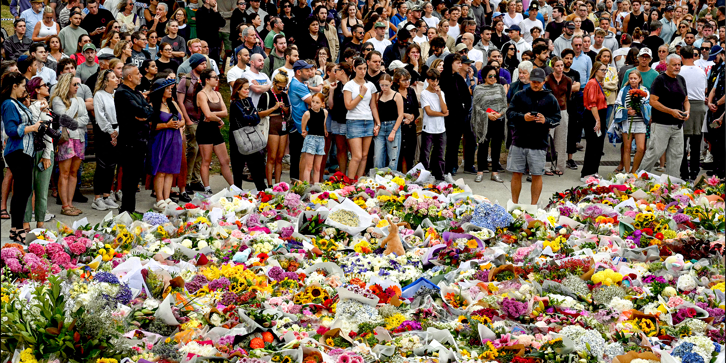 Mourners gather by floral tributes at the Bondi Pavillion in memory of the victims of a shooting at Bondi Beach | Source: Getty Images