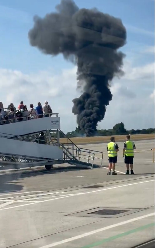 Smoke billowing from the crash site, as seen from Southend Airport. From a video dated July 13, 2025. | Source: YouTube/MrInfluenceUgReports