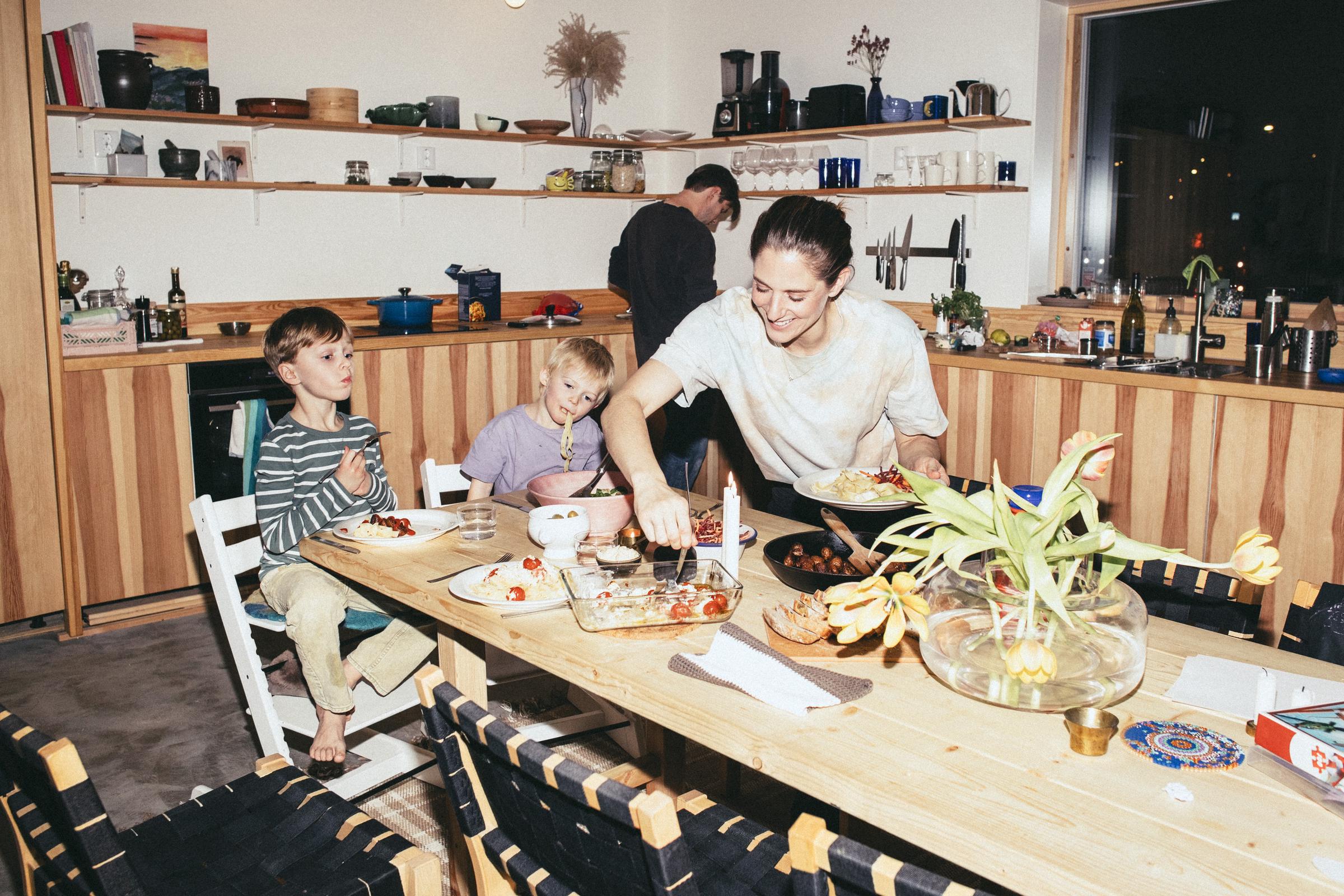 A warm family dinner brings everyone together around the table, where even the simplest homemade meals can become cherished childhood memories. Sometimes, the best part of dinner isn't the food itself, but the person who lovingly serves it. | Source: Getty Images.