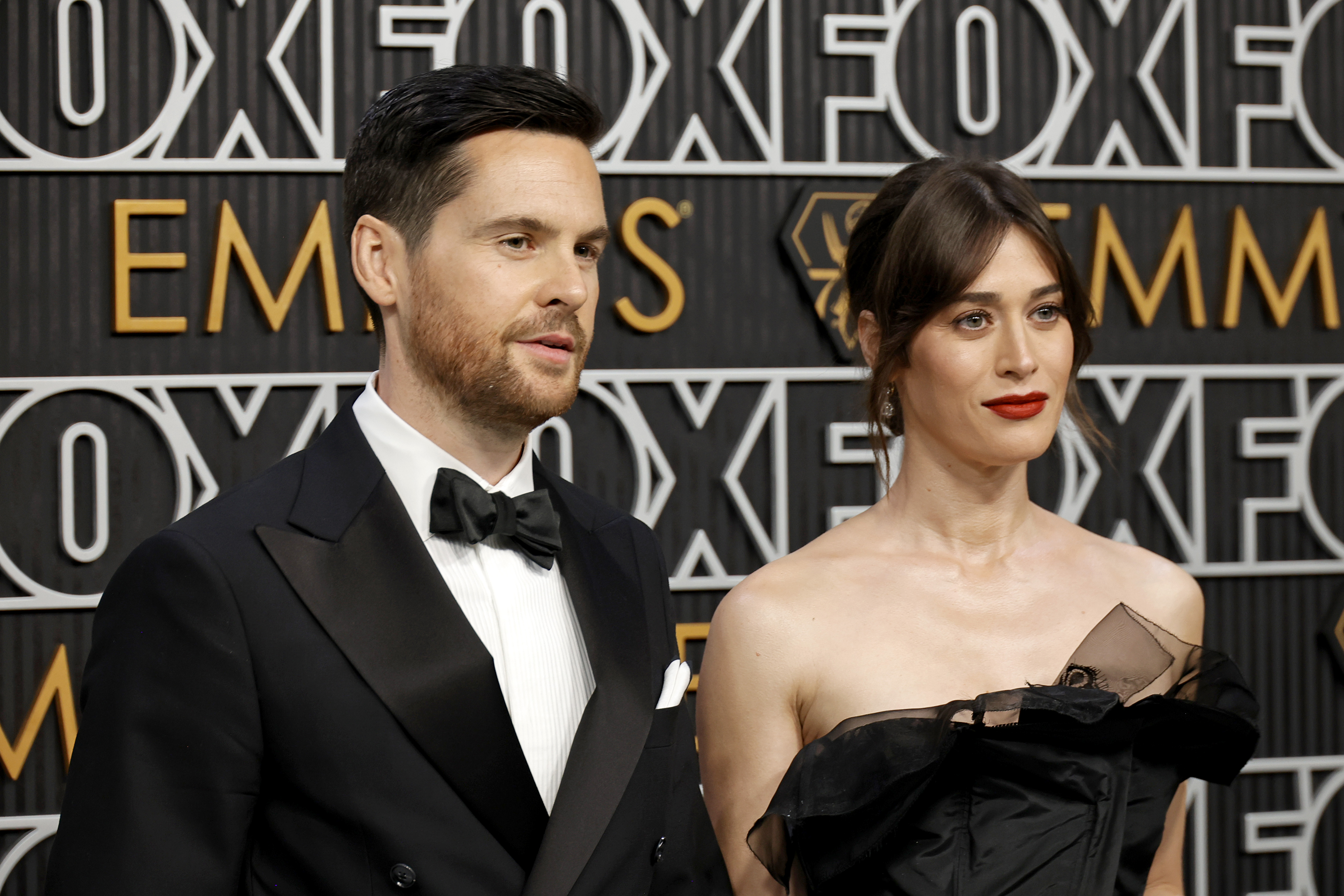 Tom Riley and Lizzy Caplan attend the 75th Primetime Emmy Awards at Peacock Theater on January 15, 2024 in Los Angeles, California. | Source: Getty Images