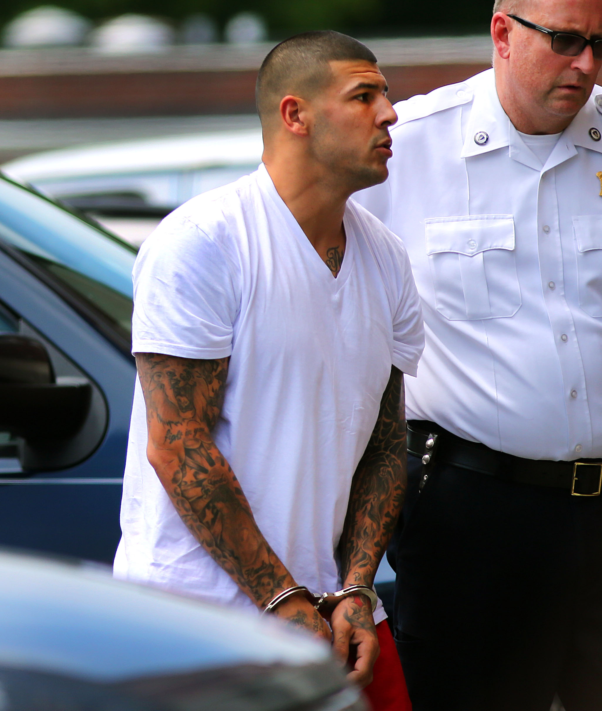Aaron Hernandez is brought into Attleboro District Court in North Attleboro, Massachusetts, on July 26, 2013. | Source: Getty Images