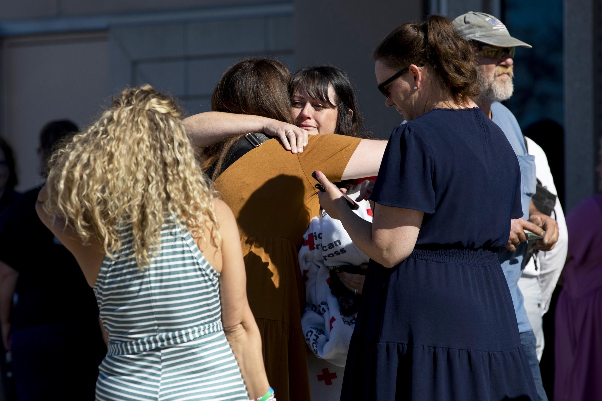 Church members and residents are overcome with emotion as they reunite at the Trillium Theater located across the street from the site of a shooting and fire at the Church of Jesus Christ of Latter-day Saints on September 28, 2025, in Grand Blanc, Michigan. | Source: Getty Images