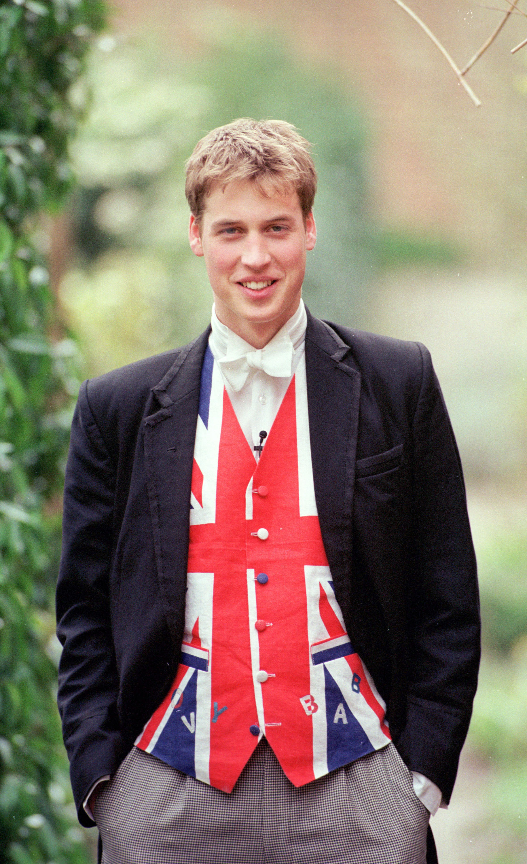 A cheerful Prince William is pictured embracing his Eton identity with a big smile and a Union Jack waistcoat in June 2000. His son will soon enroll in the all-boys boarding school William attended over two decades ago. | Source: Getty Images