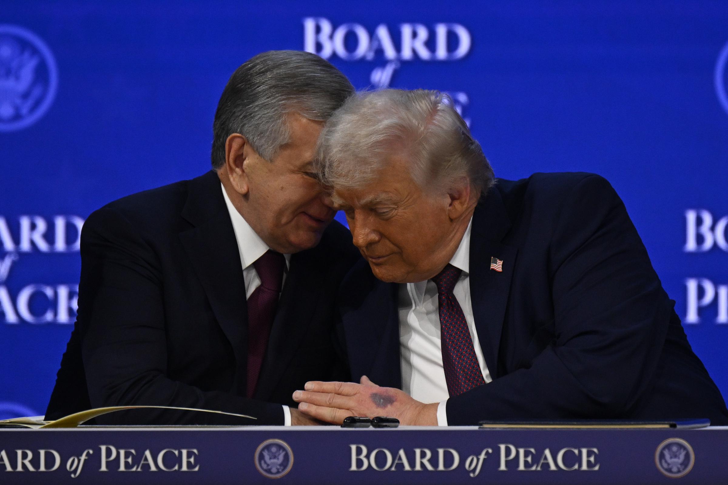 Uzbek President Shavkat Mirziyoyev speaking with US President Donald Trump during the signing ceremony of the Peace Charter for Gaza at the 56th World Economic Forum in Davos, Switzerland on January 22, 2026. | Source: Getty Images