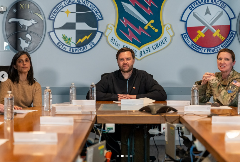 JD Vance sits at a conference table between Usha and a uniformed military officer during what appears to be a meeting at a military base. | Source: Instagram/vp