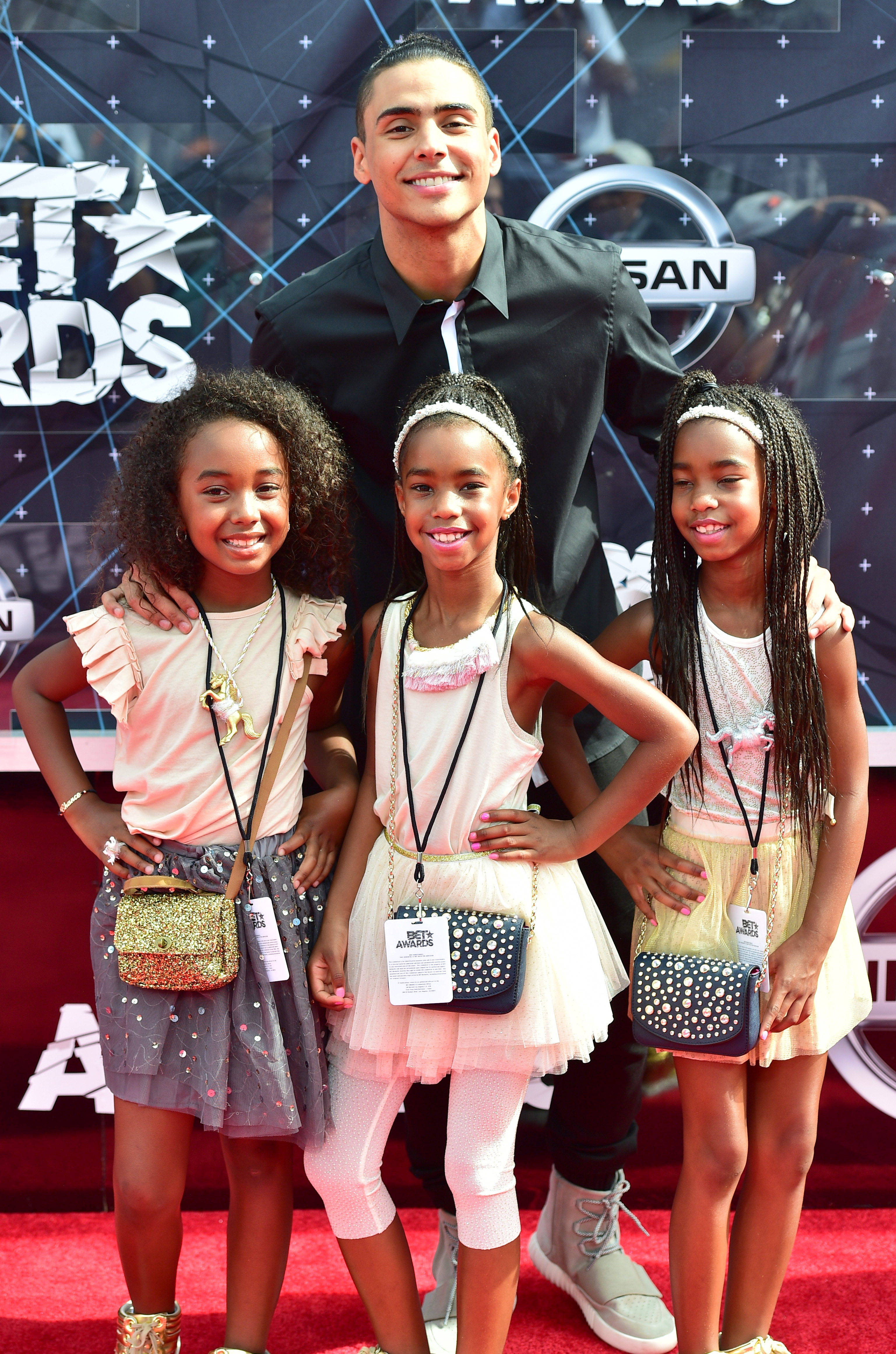 Quincy Brown poses on the red carpet with Chance, D’Lila Star, and Jessie James Combs, all dressed in coordinated pastel outfits that create a bright, youthful moment.