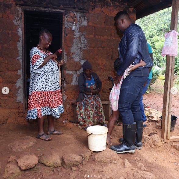 Francis Ngannou stood outside a modest brick home in Batié, Cameroon, surrounded by several people during a visit to the village where he spent much of his childhood. Shared in an Instagram post dated July 10, 2023, the photo showed the former UFC heavyweight champion dressed in dark clothing and rubber boots as he spent time back home, years after his journey from Cameroon led him to the highest level of mixed martial arts. | Source: Instagram/francisngannou