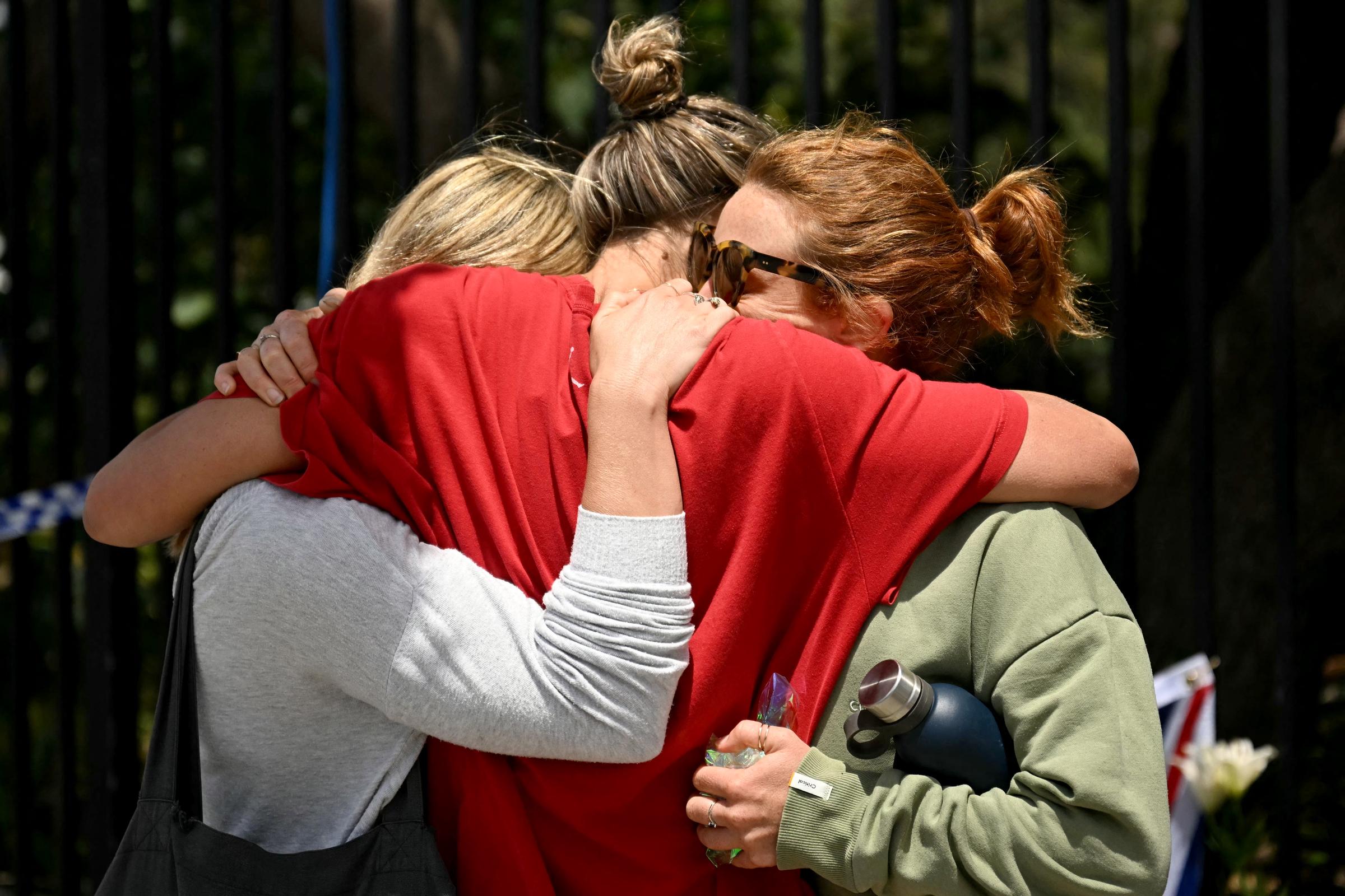 Members of the local community embrace at the Bondi Pavillion on December 15, 2025. | Source: Getty Images