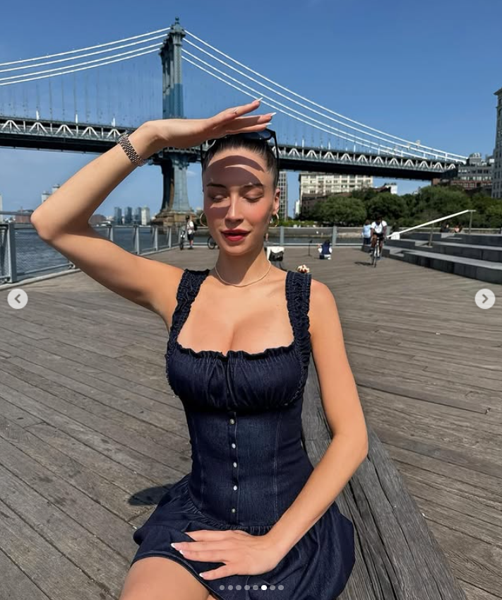Elsie Hewitt in a striking yet casual pose, with her right hand above her forehead, as if shielding her eyes from the sun, from a post dated July 12, 2025 | Source: Instagram/elsie