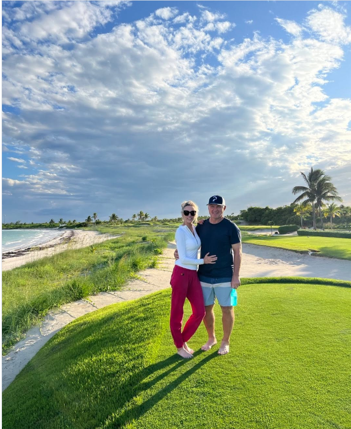 Claude Lemieux and his wife, Deborah, pose together beside a golf course overlooking the coastline in a photo she shared on Instagram. | Source: Instagram/deblemieux