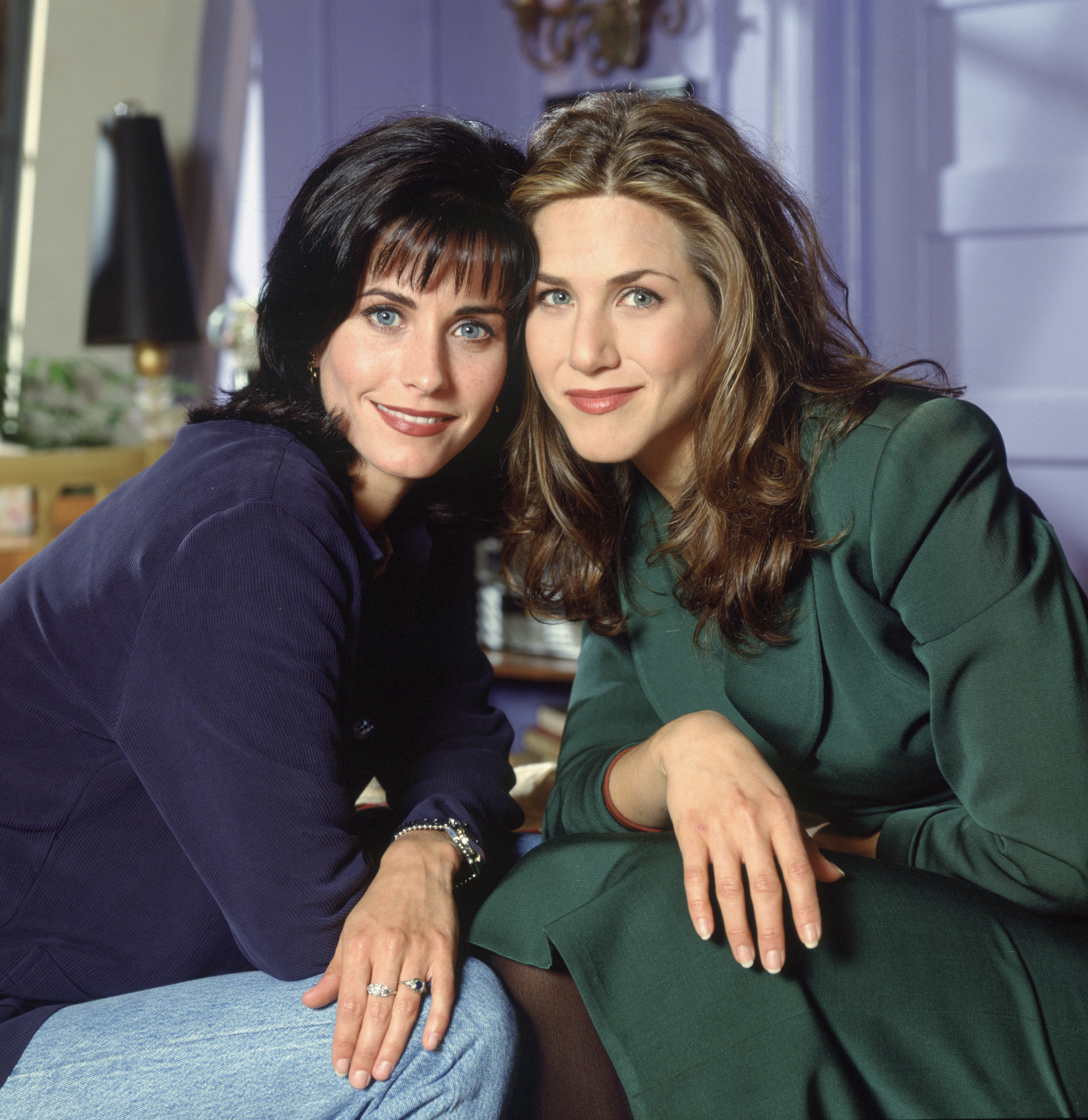 Courteney Cox as Monica Geller and Jennifer Aniston as Rachel Green in season one of "Friends." The two share striking facial features and blue eyes, with Cox sporting dark hair with a fringe while Aniston wears her signature blonde.