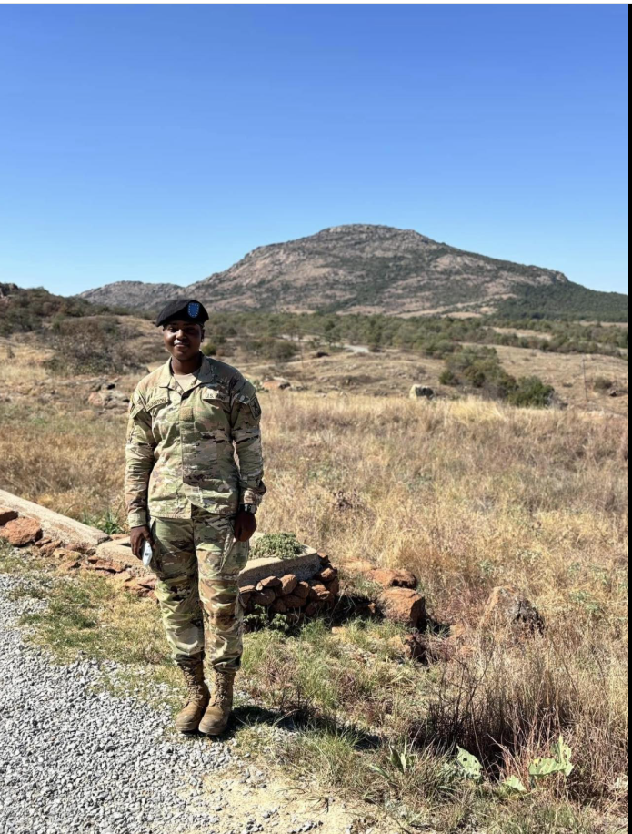 Specialist Mariyah Symone Collington stands in her U.S. Army combat uniform against a rugged landscape of dry grasslands as seen in a post dated May 14, 2026. | Source: Facebook/Lake and Sumter Style Magazine