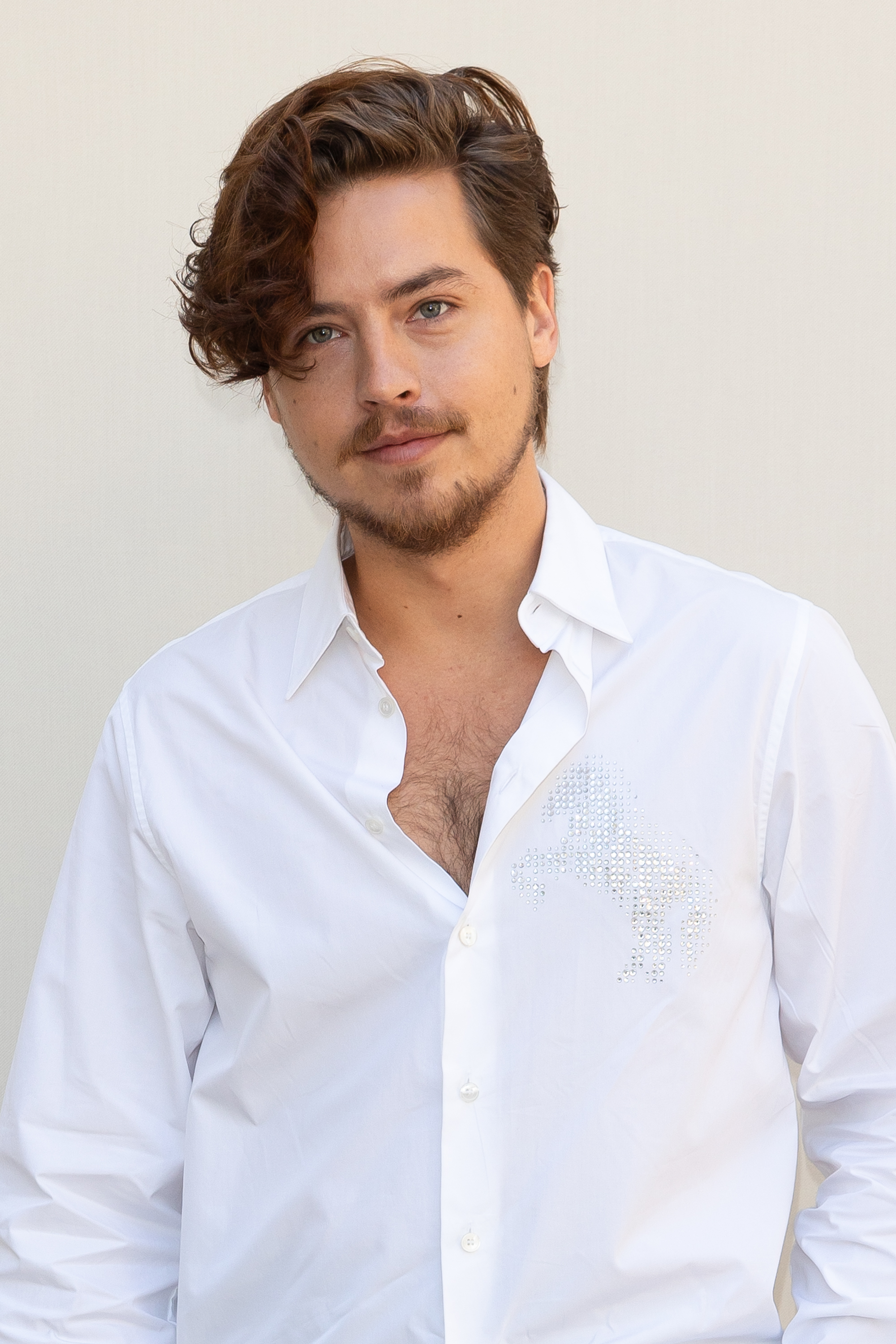 Cole Sprouse at the Stella McCartney Womenswear Spring/Summer show in Paris, posing during a photocall | Source: Getty Images