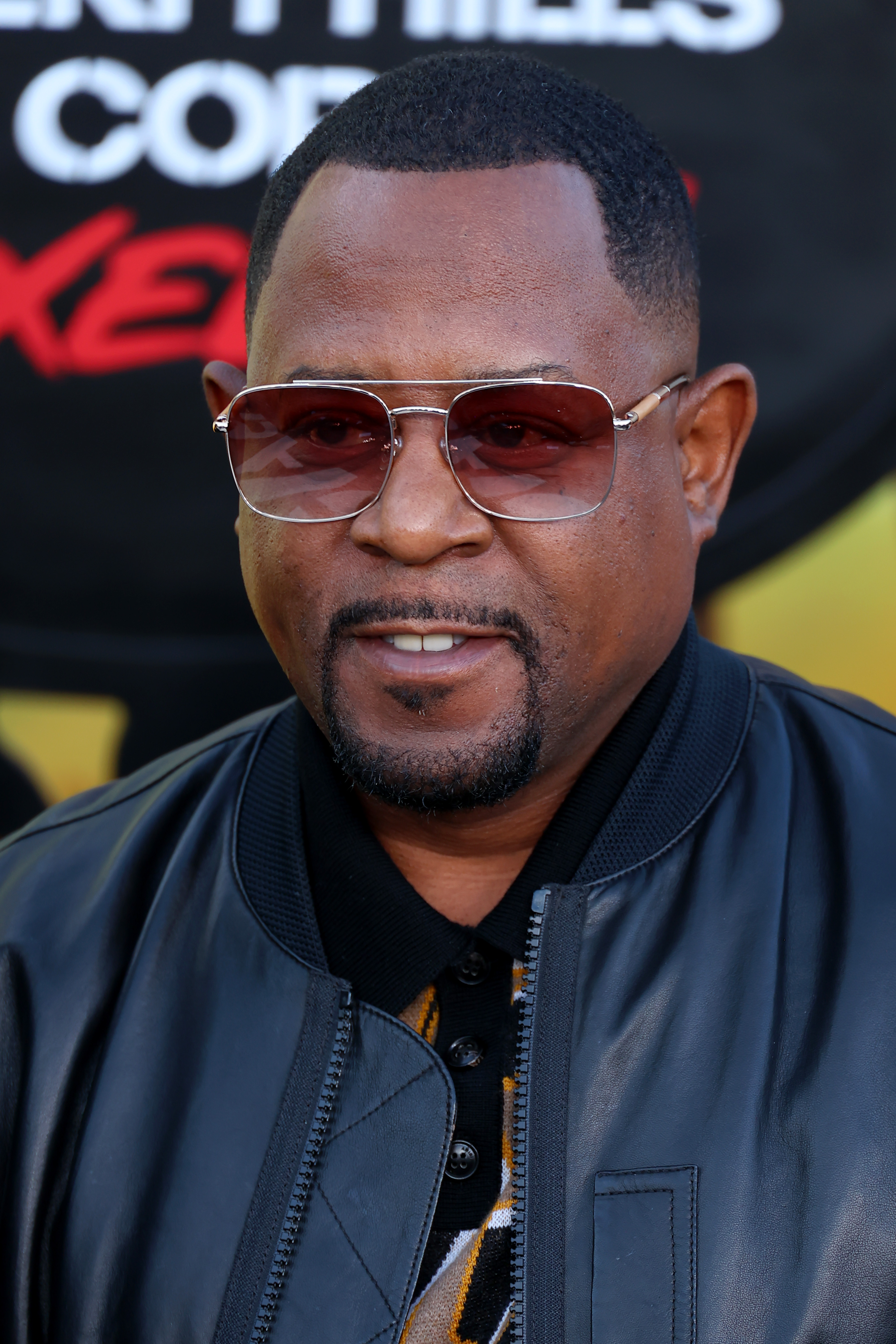 At the Los Angeles premiere of "Beverly Hills Cop: Axel F," Martin Lawrence wears a black leather jacket and tinted glasses. He faces the camera with a slight smile, his look polished yet relaxed.