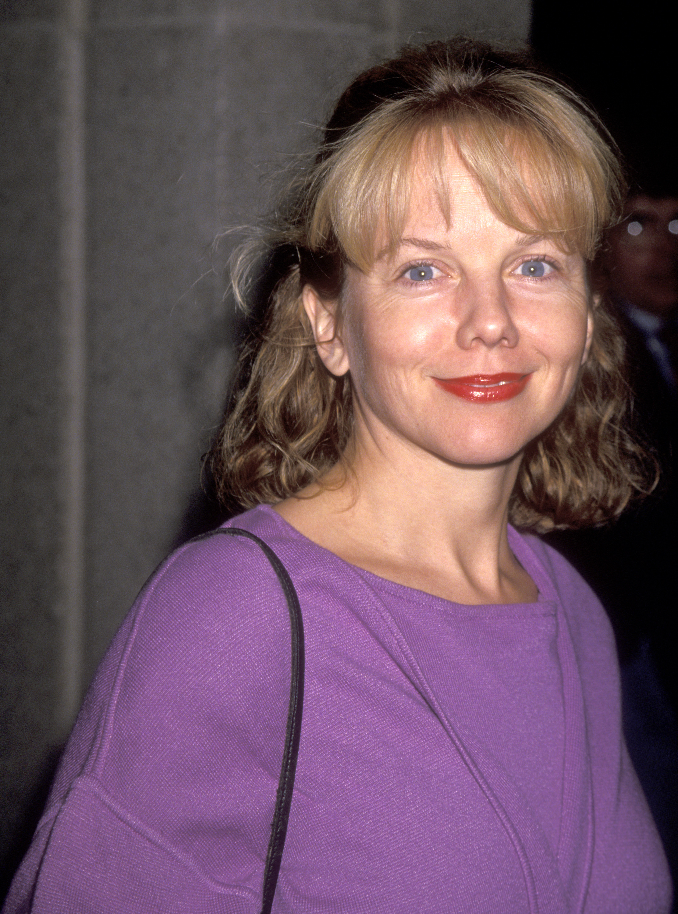 A vibrant lavender knit sweater highlighted 38-year-old Linda Purl’s casual grace at the opening night of "Pounding Nails in the Floor with My Forehead" at the Mark Taper Forum on November 2, 1993. Her face showed the refined, softening contours of her late 30s, complemented by a warm glossy red lip, bright blue eyes, and shoulder-length brown waves topped with light blonde fringe. | Source: Getty Images