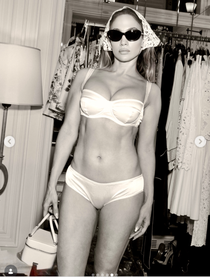 Jennifer Lopez poses for a close-up in white lingerie, sunglasses, and a headscarf. | Source: Instagram/jlo