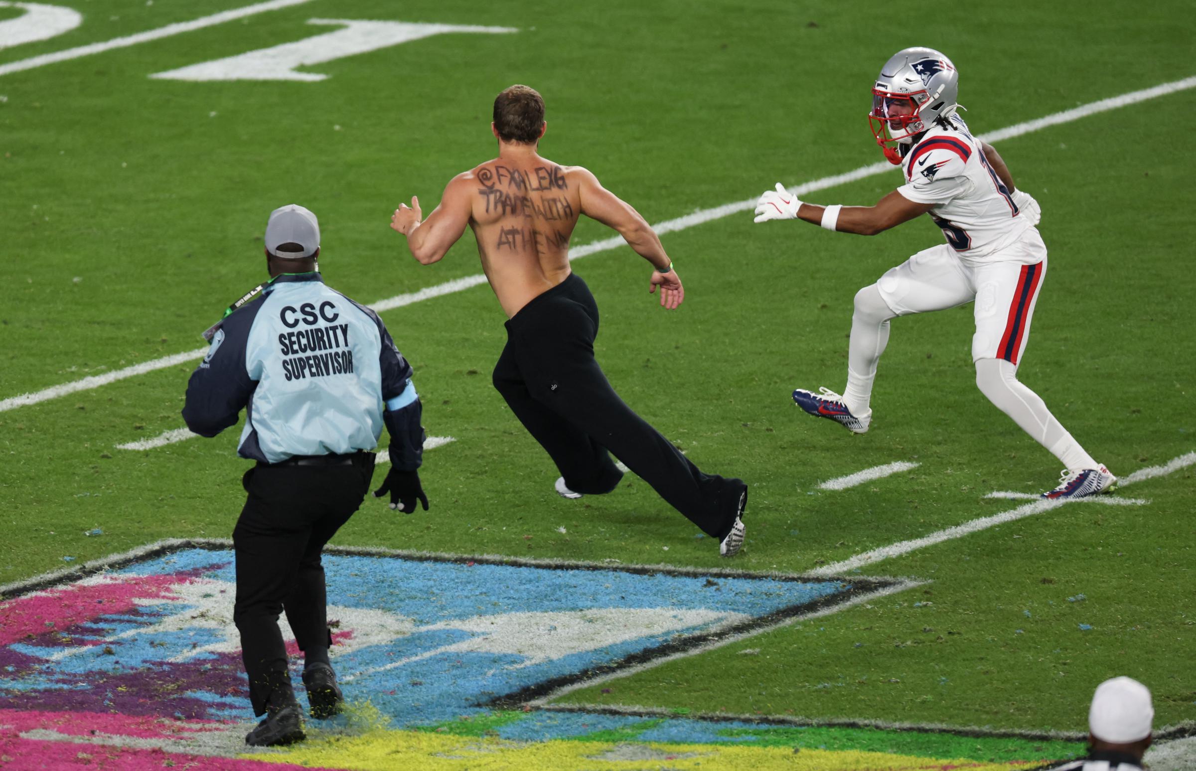 Kyle Williams helps security corral a streaker during Super Bowl LX at Levi's Stadium on February 8, 2026, in Santa Clara, California | Source: Getty Images