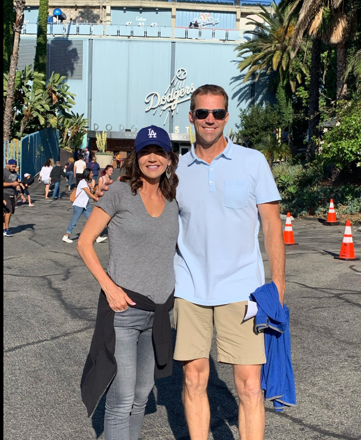 Casual and cheerful outside Dodger Stadium, Kristi Noem and Bryon Noem blend into a crowd — just another day, side by side. | Source: Facebook/KristiNoem