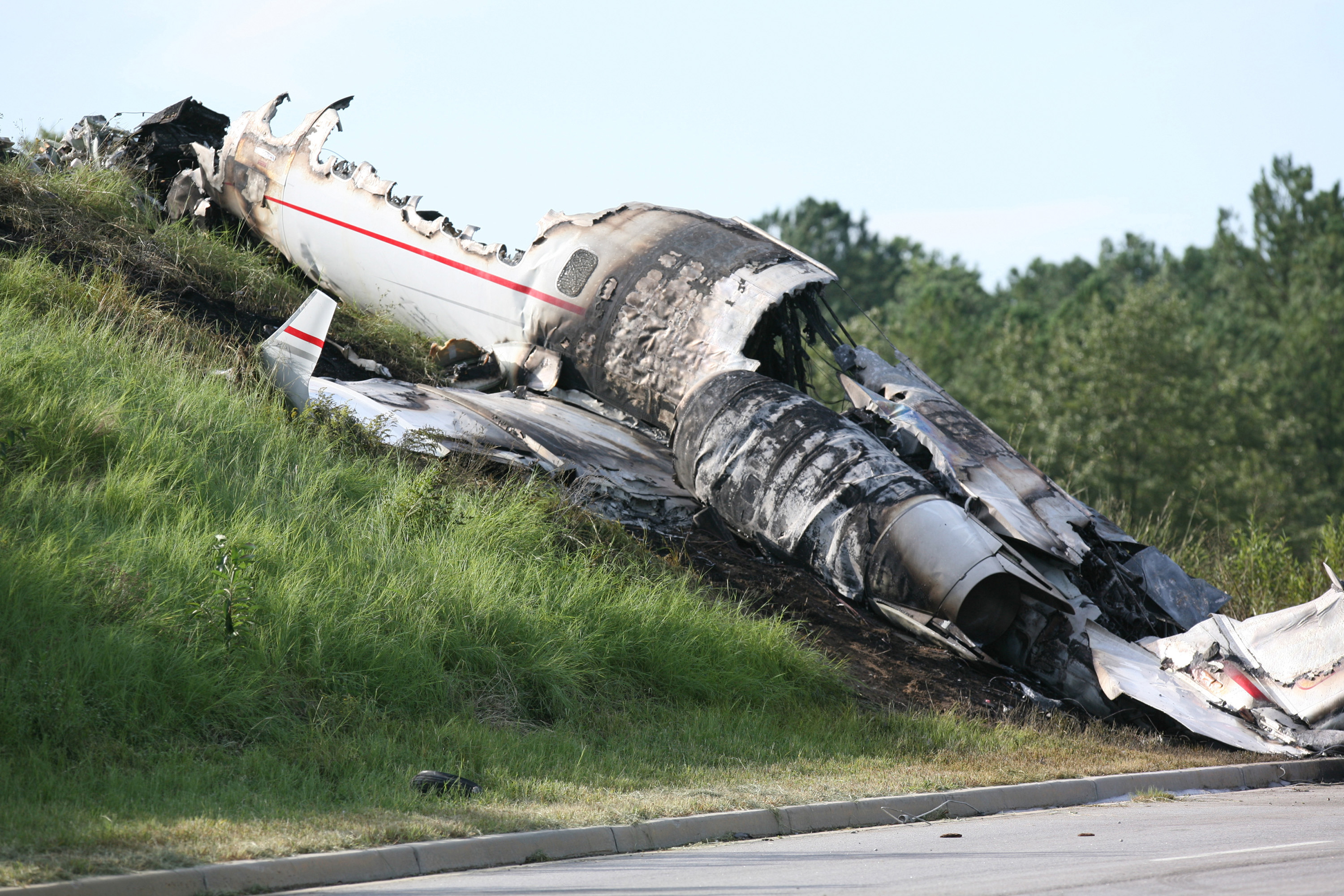 The charred wreckage of the private jet carrying Travis Barker, Adam "DJ AM" Goldstein, and four others lay near Columbia Metropolitan Airport in West Columbia, South Carolina, on September 20, 2008. | Source: Getty Images