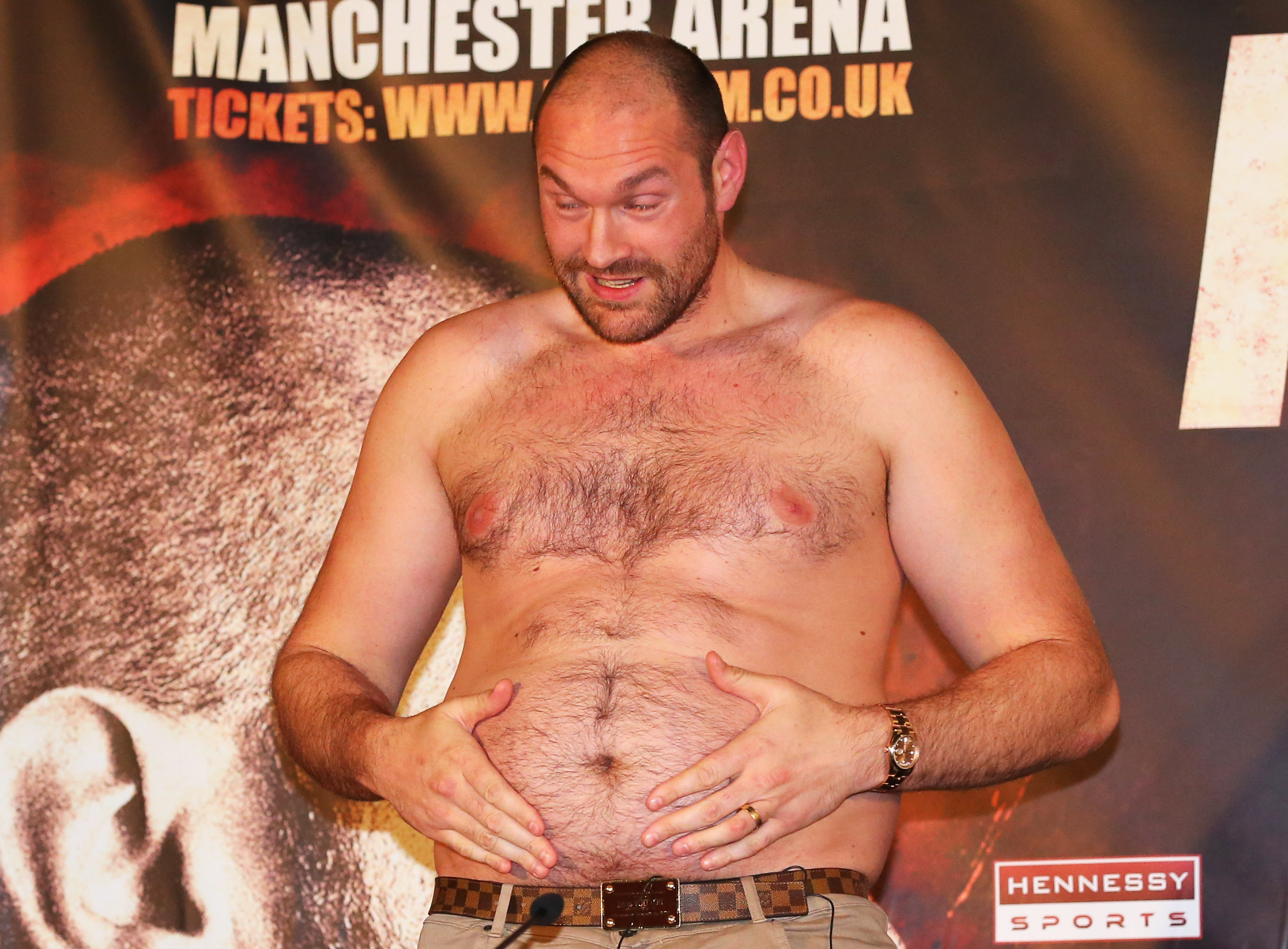 Tyson Fury cut a striking figure as he playfully grabbed his stomach during a press conference at Manchester Arena in Manchester, England, on April 27, 2016. Just five months earlier, Fury had produced a stunning upset against Wladimir Klitschko, defeating the long-reigning champion on November 28, 2015, to reach the top of the heavyweight division.