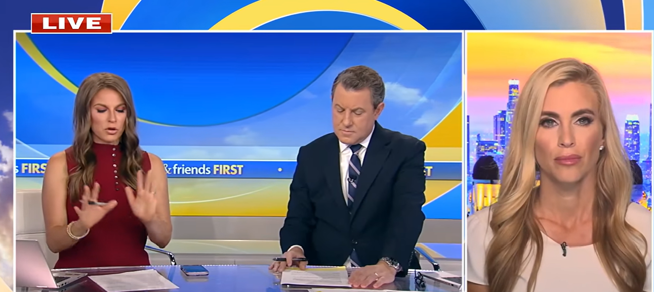 Katie Zacharia appears on a live television interview on August 31, 2026, wearing a white top and speaking remotely with two studio presenters. | Source: YouTube/Fox News Clips