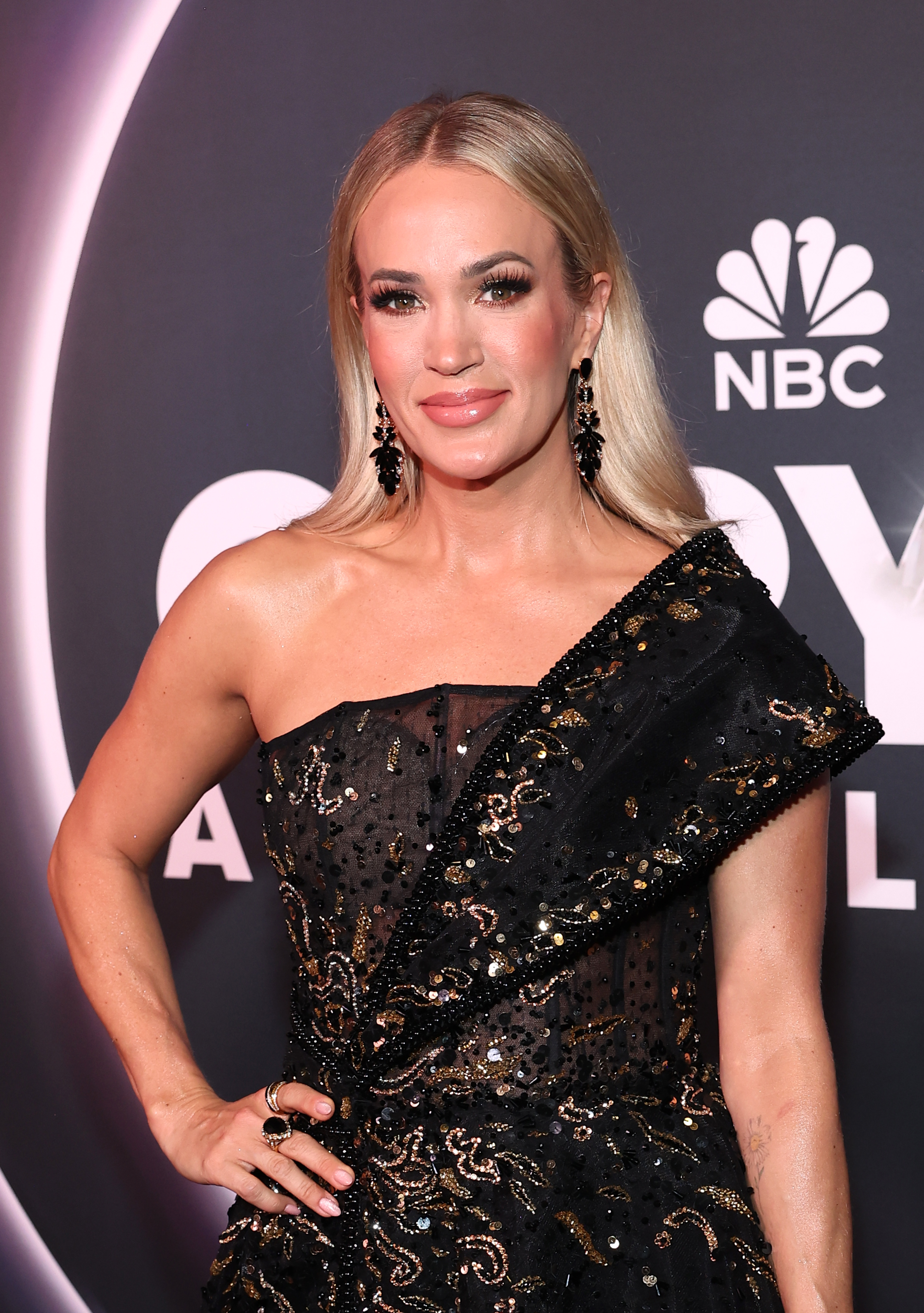 Underwood attended NBC's "Opry 100: A Live Celebration in Nashville" wearing a black one-shoulder gown with her hair styled straight and tucked behind her shoulders. The appearance came as discussions about her evolving look continued online. | Source: Getty Images